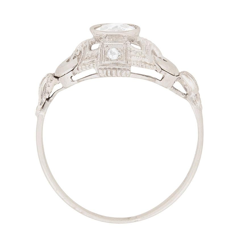 This ring features a rub over set diamond weighing 0.50 carat in the centre. The diamond is a hand cut old cut diamond estimated as an I in colour and SI2 in clarity. The surrounding design is intricate and beautifully art deco. The exquisite metal