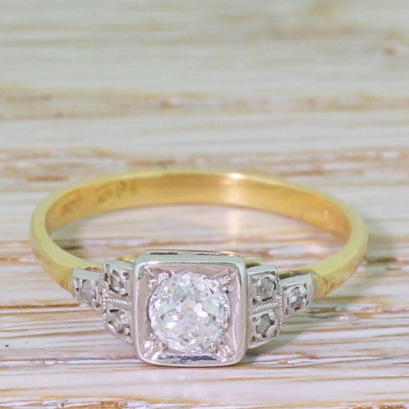 One of the most beautiful vintage solitaire rings we’ve ever seen. The old mine cut diamond – graded by IGR as D to E colour – is phenomenally white and bright, and is secured in a platinum box setting. Six (three either side) rose cut diamond are