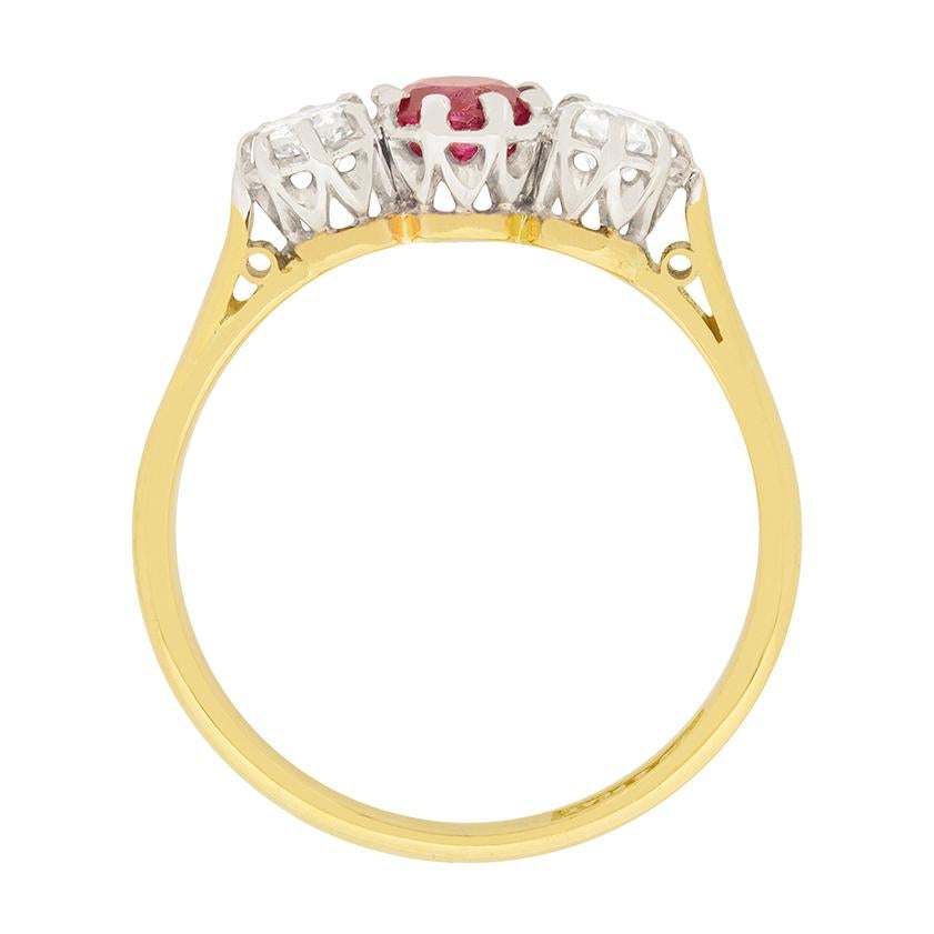 A gorgeous ruby is the centre of this 1930s three stone ring. The old cut ruby is 0.50 carat, and is a deep red colour. To either side of the ruby is a 0.25 carat transitional cut diamond. They match in size and quality, with colour grades of F, and