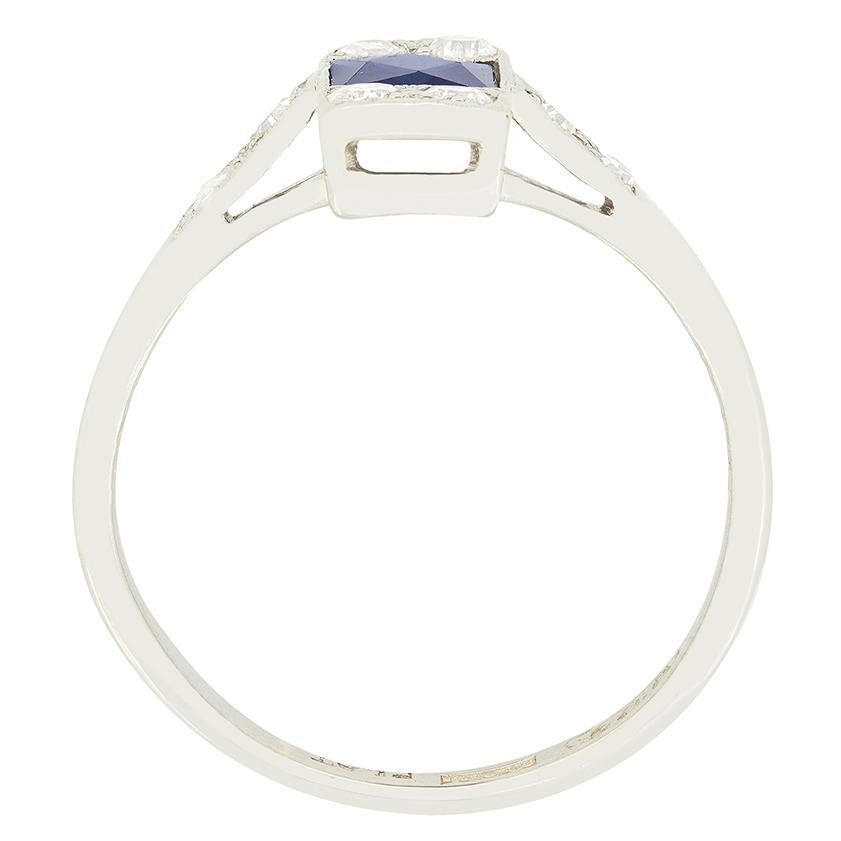 A wonderful French cut sapphire is accompanied by old cut diamonds in this beautiful Art Deco Ring. The deep blue sapphire weighs 0.50 carat and is rub over set into platinum. Two old cut diamonds are set both above and below the central stone,