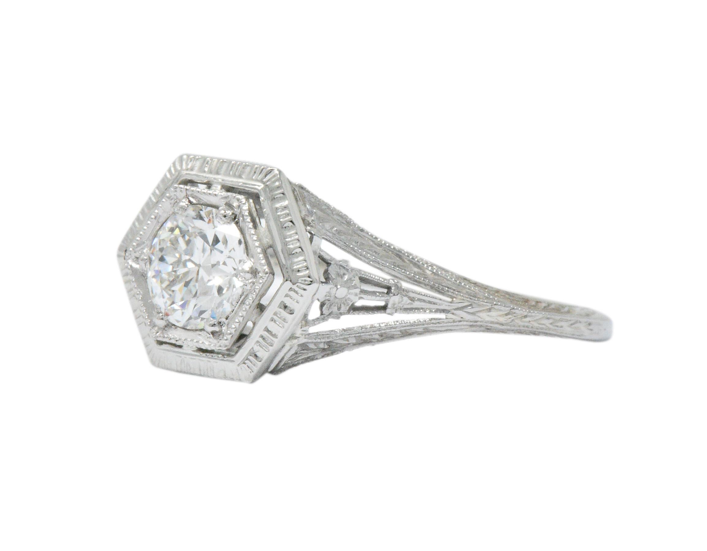 Centering an old European cut diamond weighing 0.51 carat, K color with VS clarity

Bead set in a milgrain octagonal head echoed by an octagonal surround featuring deeply engraved details

Flanked by delicately split shoulders decorated with a