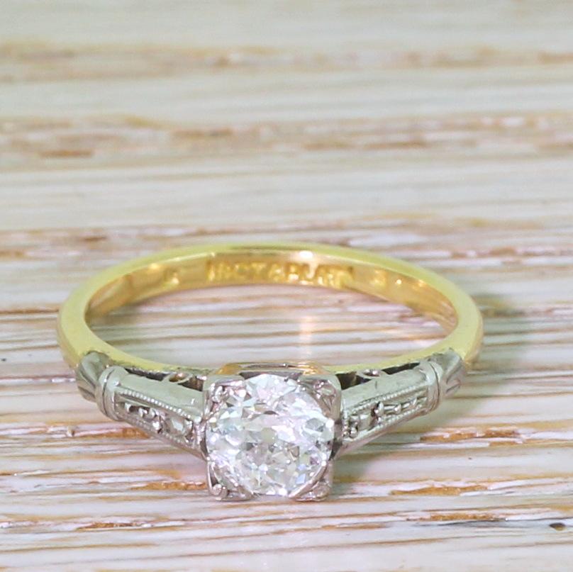 A lovely antique diamond ring, The old European cut diamond in the centre – graded by HRD Antwerp as H colour, SI1 clarity – is burstingly white and lively. The stone is secured in a four-claw square platinum collet, with finely milgrained and