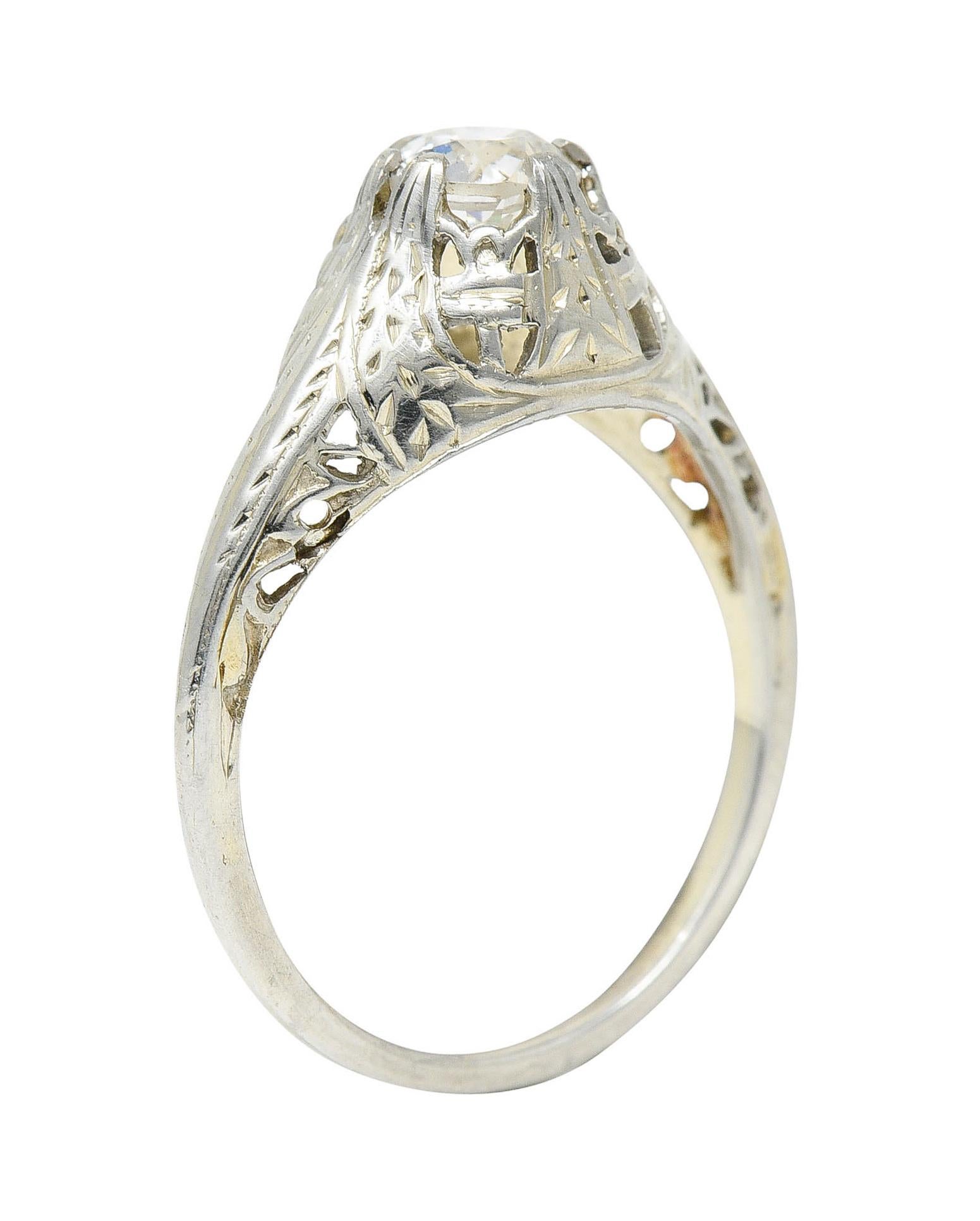 Featuring an old European cut diamond weighing approximately 0.52 carat - J/K color with VS2 clarity

Set by split and stylized foliate prongs in a pierced bombè mounting

Completed by whimsical foliate and floral designs

Stamped 18K for 18 karat