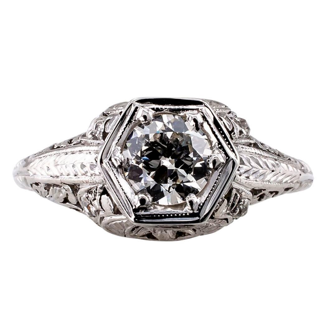 Circa 1925 Art Deco 0.55 carat diamond engagement ring mounted in platinum. The slightly domed design centers upon a round transitional cut diamond weighing approximately 0.55 carat, approximately H color and SI1 clarity, mounted on a genuine Art