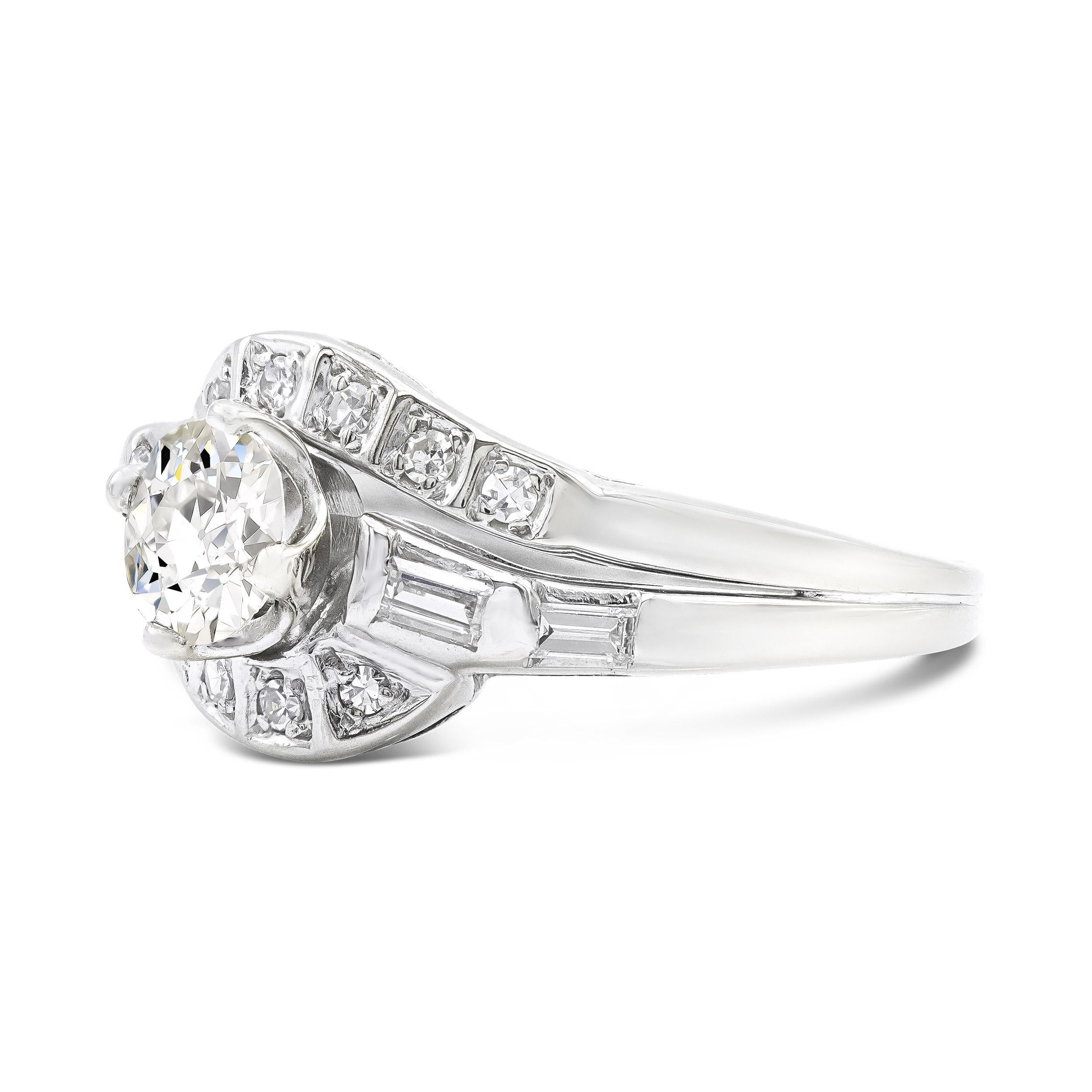 A brilliant 0.58 carat old European cut diamond centers this bypass style Art Deco engagement ring. Framed by a swirled diamond studded setting, the ring features white single cut and baguette accents fashioned in sleek platinum. This ring is made