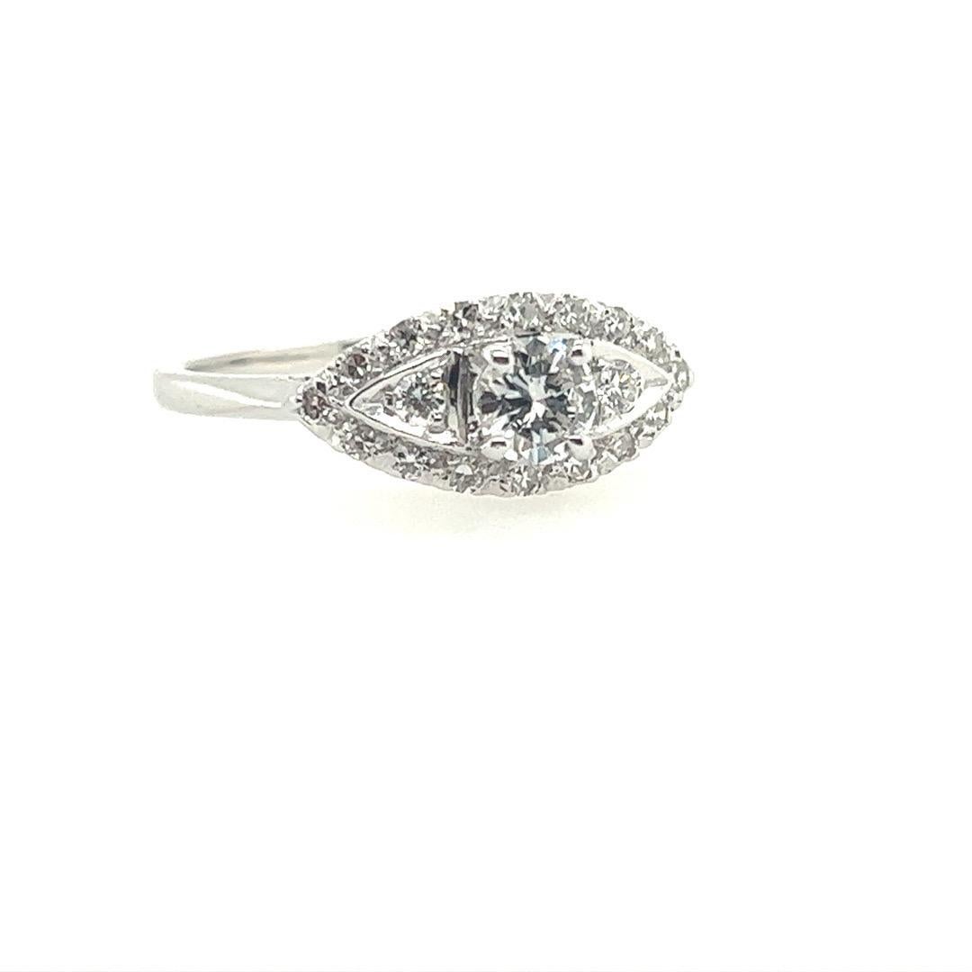 A magnificent Art Deco white gold & 0.65 carat natural diamond engagement ring.

The ring is set with a natural Round Brilliant diamond (appx 0.35 carat) centerstone, approximately G in color and VS in clarity. 

Included are 18 natural single cut