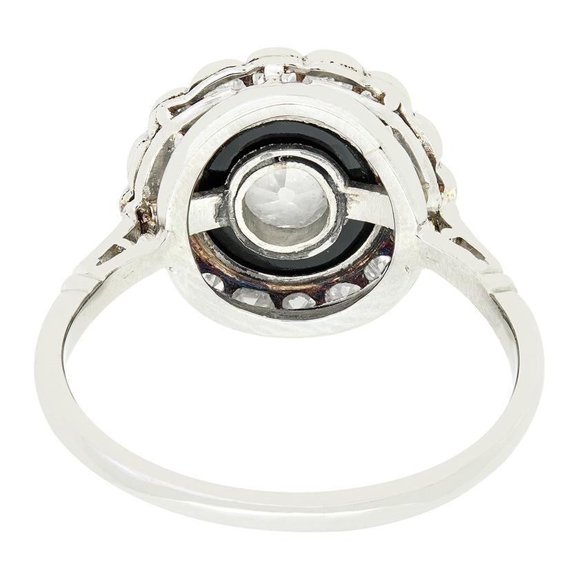 A 0.65 carat old cut diamond is set within a ring of intense onyx in this beautiful target ring from the art deco period.  The unbroken ring of deep black onyx gives an eye catching contrast to the sparkling white of the diamonds. A further ring of