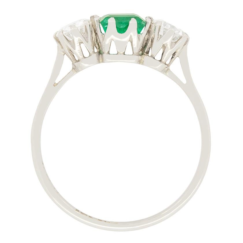 A beautiful three stone here dating back to the Art Deco period. It features a beautiful 0.65 carat Carre cut emerald in its centre. The forrest green emerald is flanked by two transitional cut Diamonds. These diamonds are 0.35 carat a piece and are