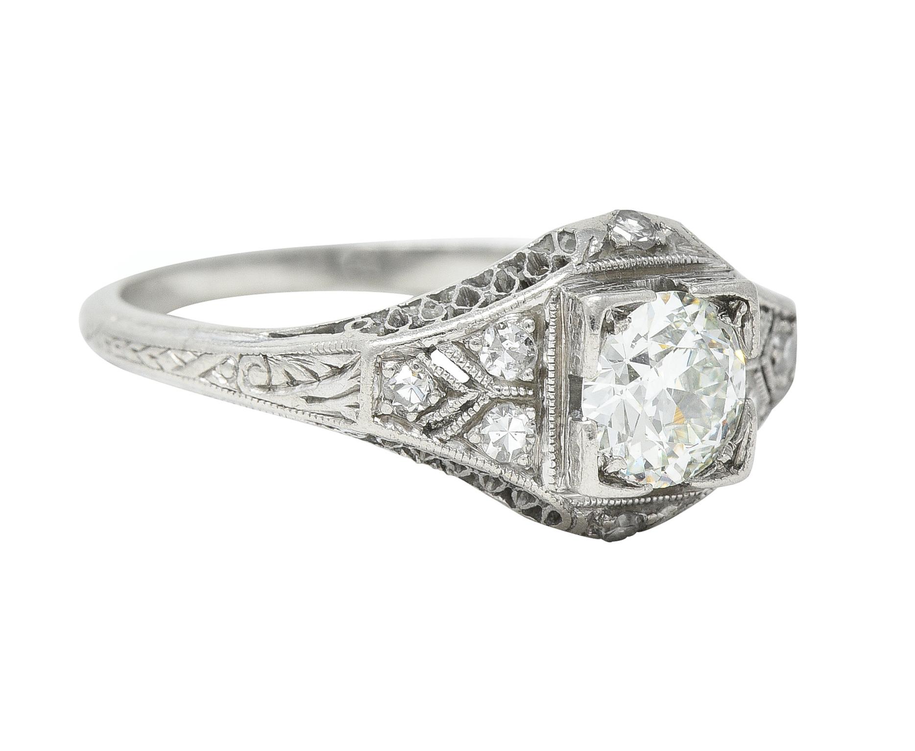 Centering an old European cut diamond weighing approximately 0.55 carat - H color with VS1 clarity
Bead set in a grooved square form head and flanked by pierced geometric shoulders
Accented by a pierced lattice motif profile with bead set single-cut