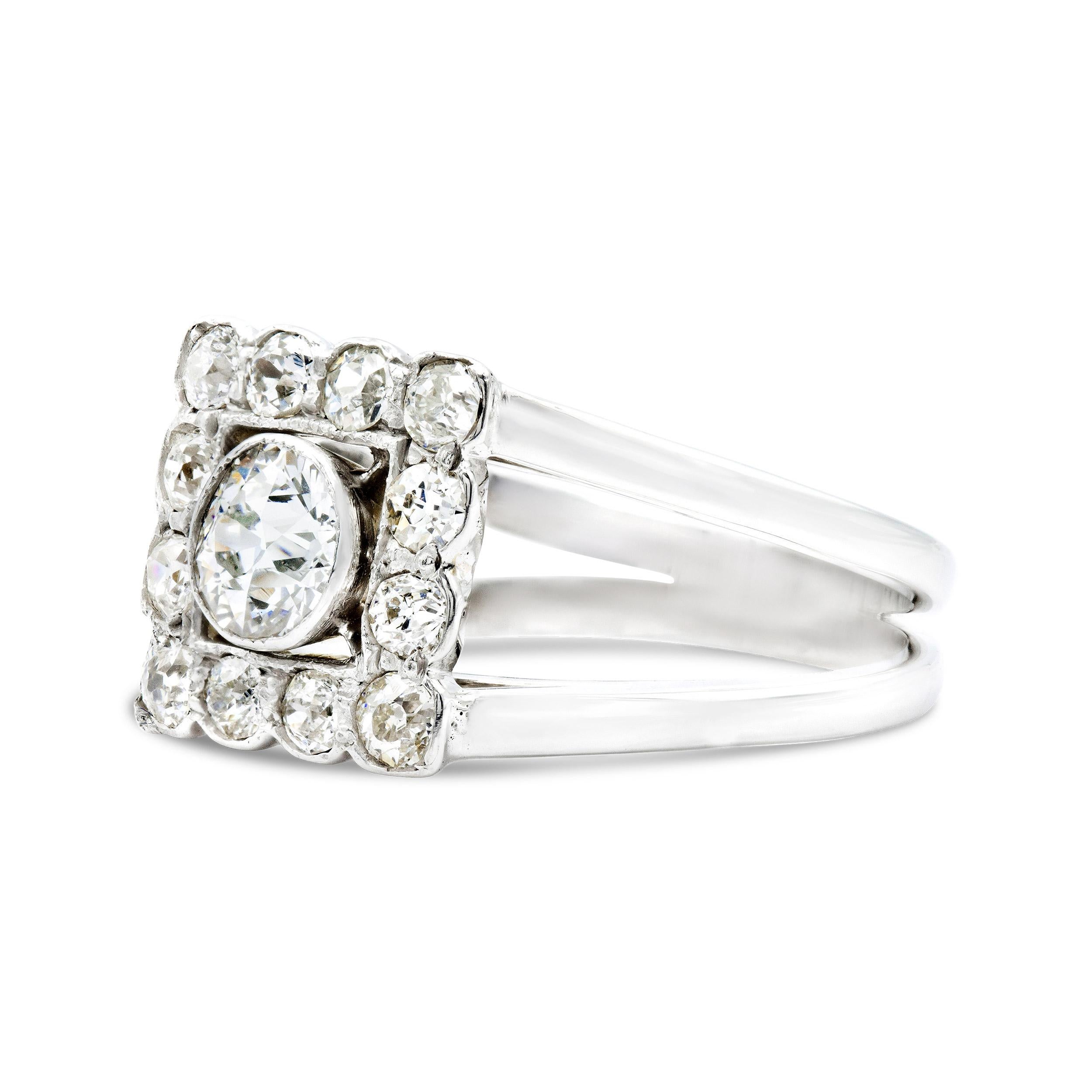 Shining from the center of this Art Deco diamond ring is a bezel-set old European cut diamond, irresistibly bright and full of life. Its sparkle is enhanced by a frame of smaller old Euros, bringing the total weight of this piece to just under 1.50