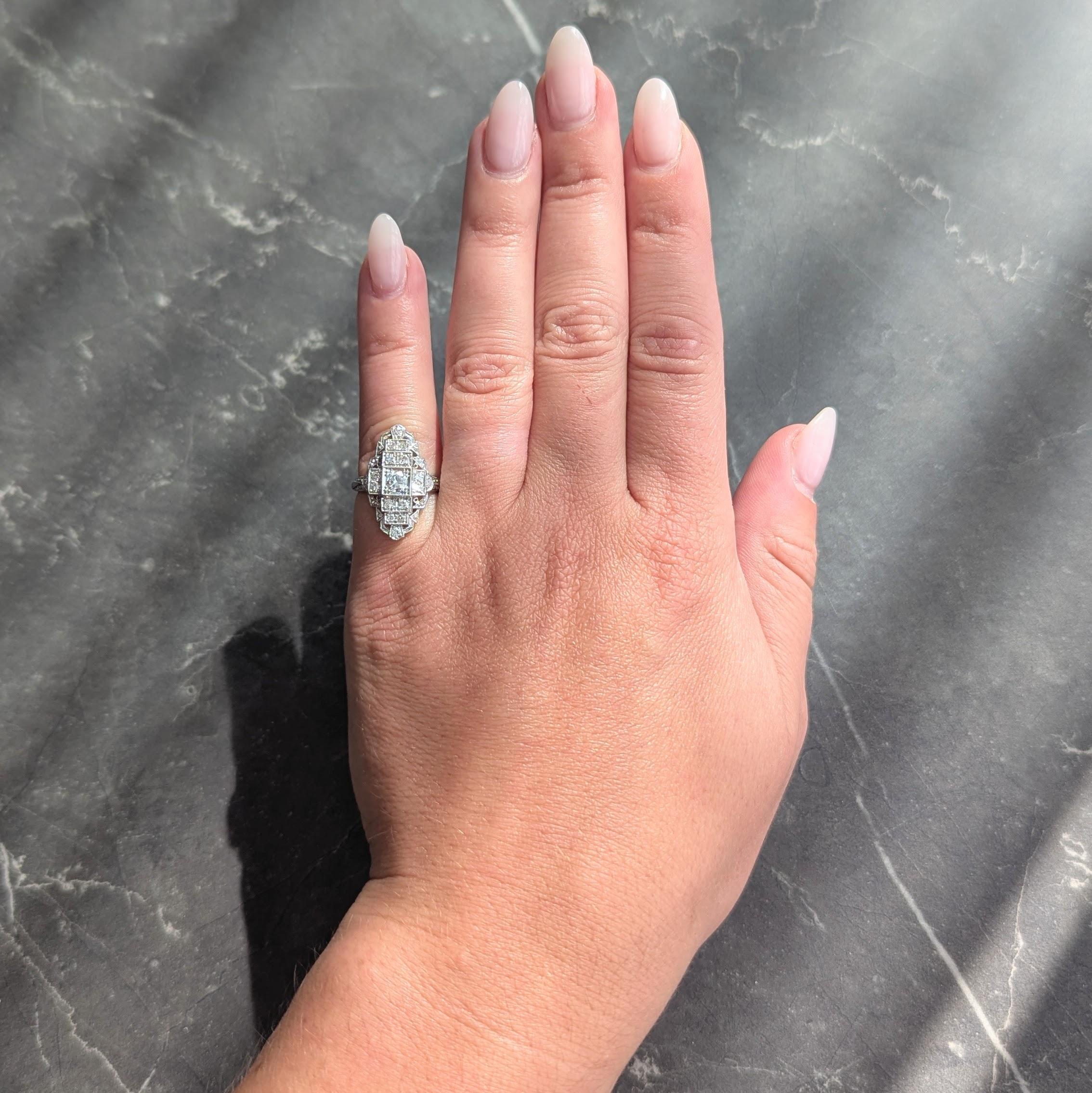 Centering an old European cut diamond bead set in a square form head
Weighing approximately 0.25 carats total - G color with VS2 clarity
With a navette shape surround displaying a stepped streamline motif
Bead set with additional single cut diamonds