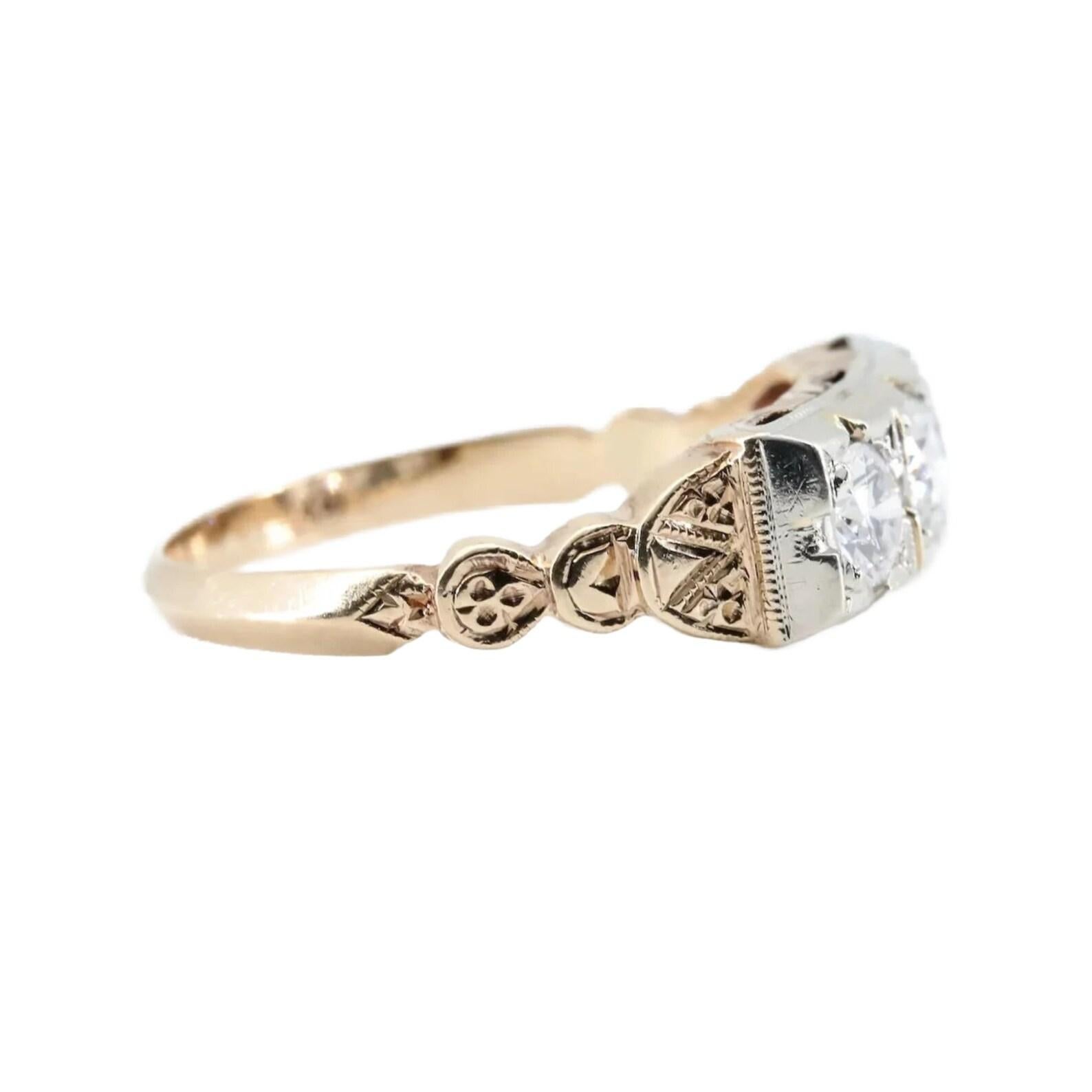 A three stone Art Deco period European cut diamond ring featuring hand engraved detailing. Centering this ring is a 0.30ct old European cut diamond accented by two matched 0.40ctw diamonds. The trio of sparkling diamonds grade as G/H color and VS2