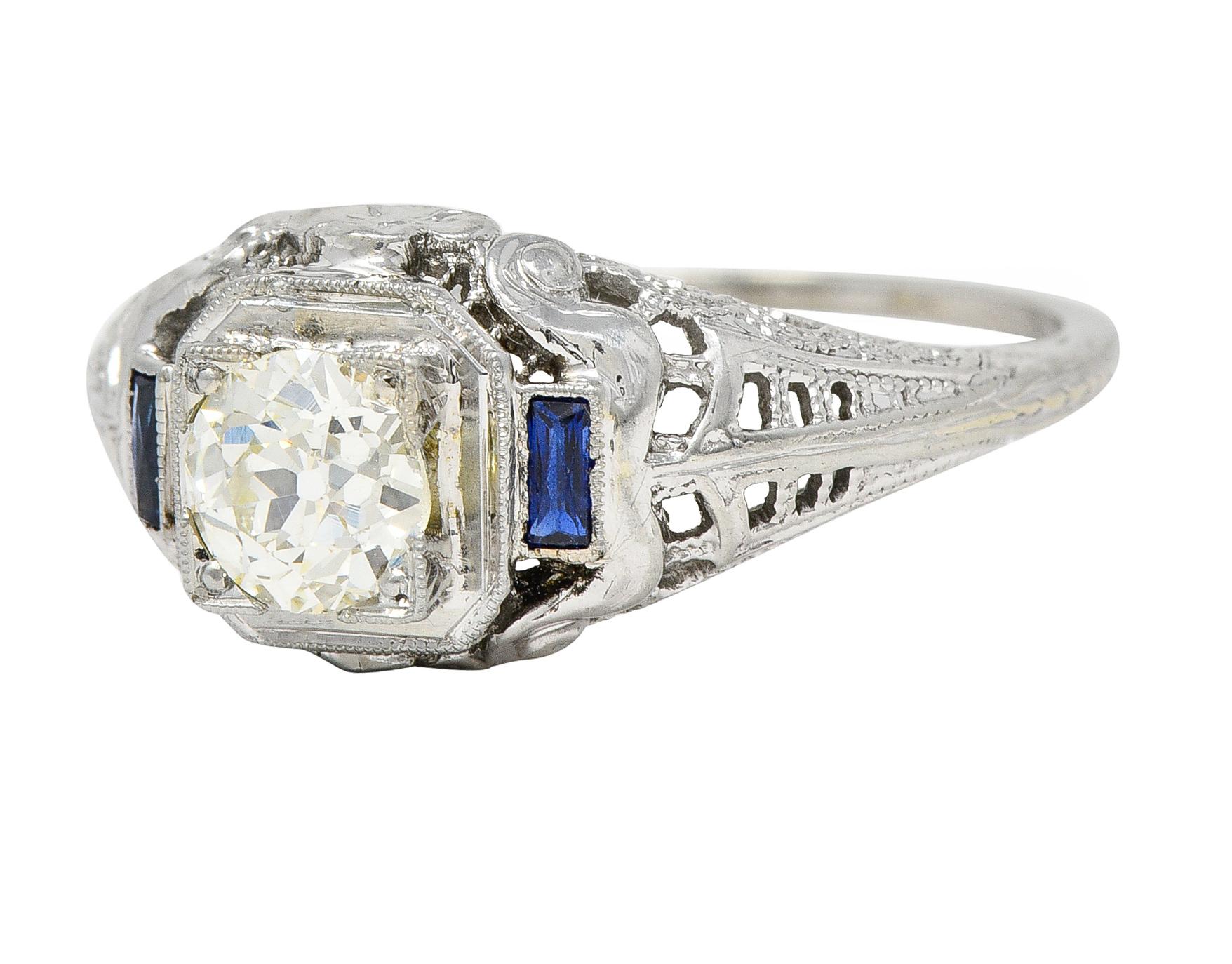 Centering an old European cut diamond weighing 0.59 carats - O/P color with VS1 clarity
Bead set in a square form head and flanked by French cut sapphires bezel set at shoulders 
Transparent medium blue in color and weighing approximately 0.12 carat