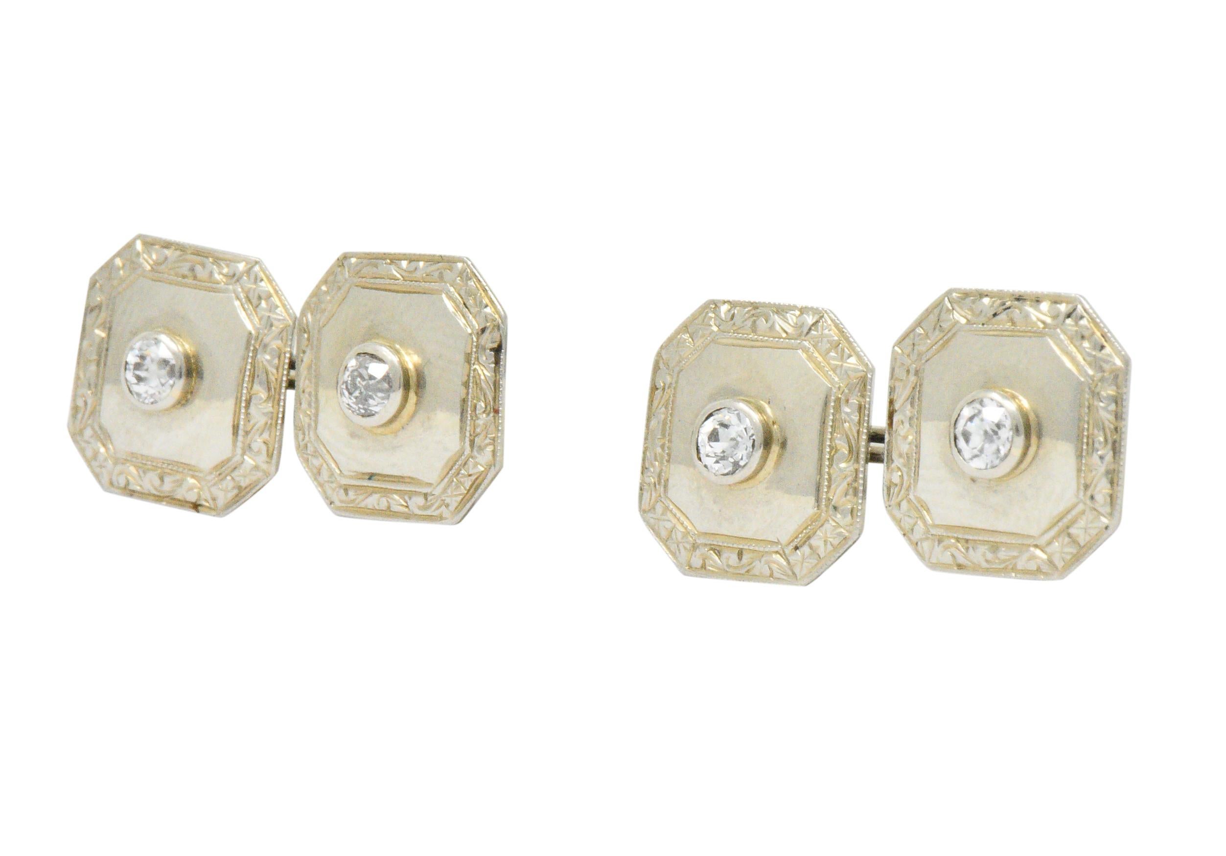 Each centering old European cut diamonds, four total weighing approximately 0.72 carat total, G/H color and VS2-SI2 clarity

Cut-corner square form with miligrain edge and scroll work border link style cufflinks

Tested as 18k gold

Measures: 1/2 x