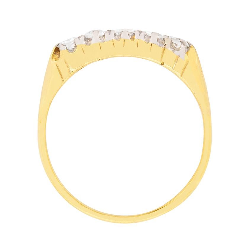 Five old cut diamonds are set side-by-side in platinum to accentuate their bright white F colour, within a contrasting 18 carat yellow gold setting at the heart of this c.1920s antique ring. The clarity is graded as VS2 and the handmade nature of