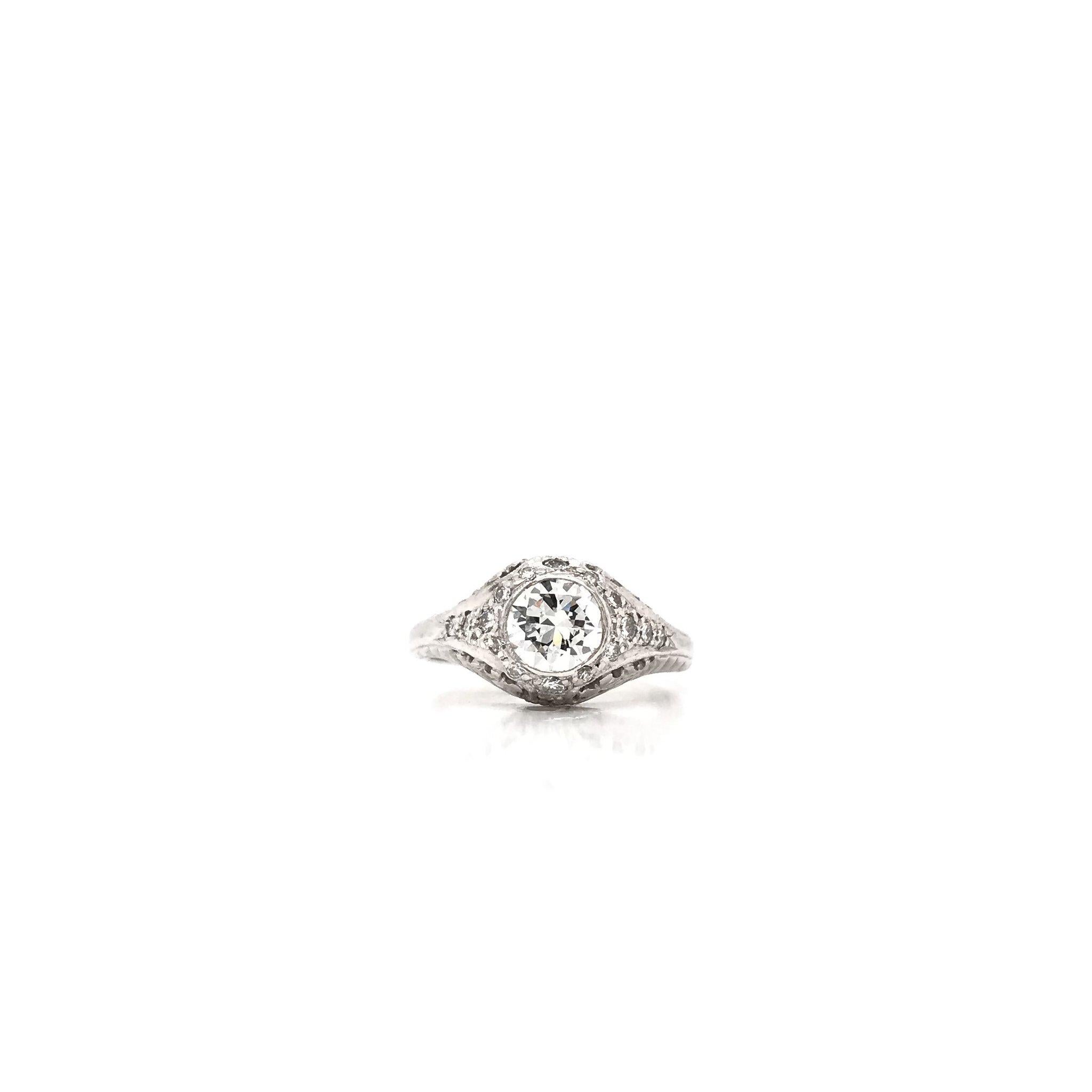 This antique piece was handcrafted sometime during the Art Deco design period ( 1920-1940 ). The setting is platinum and features a 0.75 carat center diamond. The center diamond is an old european cut, grades approximately J in color, and VS1 in