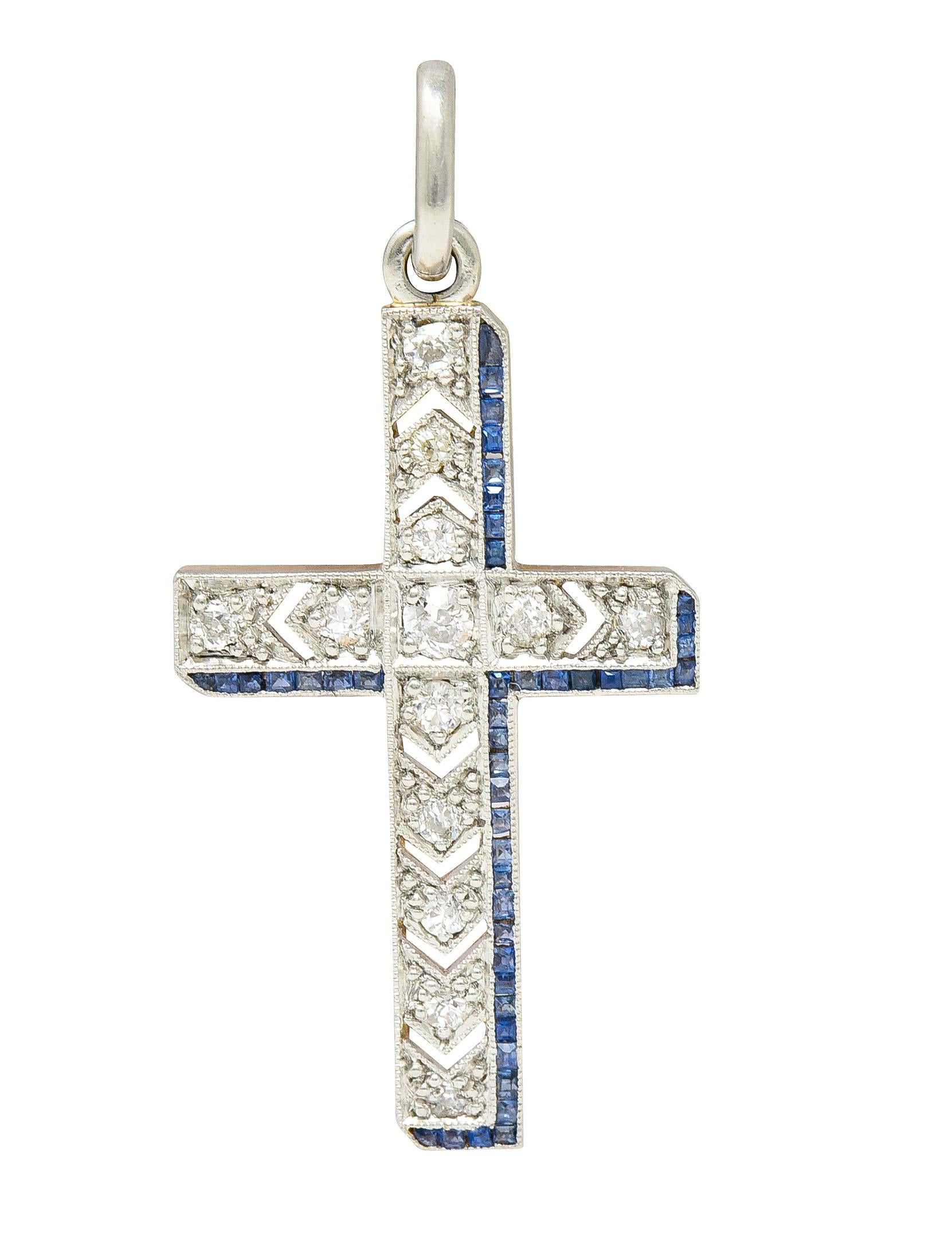Designed as a platinum-topped cross form with old European cut diamonds bead set throughout. Weighing approximately 0.30 carat total - eye clean and bright. With square step cut sapphires channel set along edges. Weighing approximately 0.45 carat