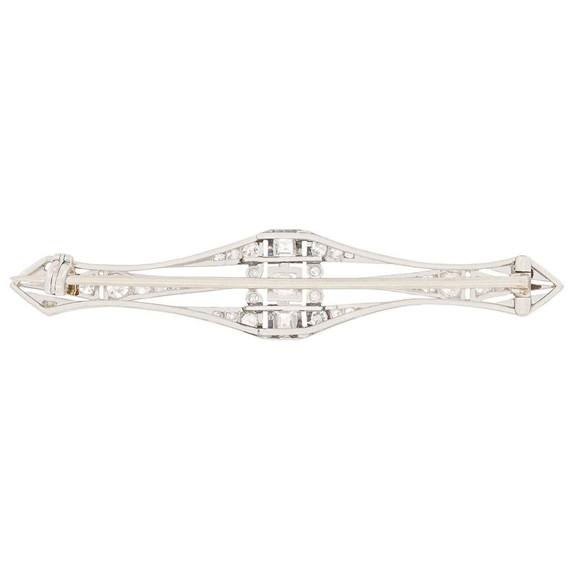 This stunning brooch dates back to the roaring 20s. The bold geometric shapes crafted from platinum is a hallmark of the Art Deco period and gives this piece its character. Central to the piece are three carre cut diamonds, each weighing 0.25 carat