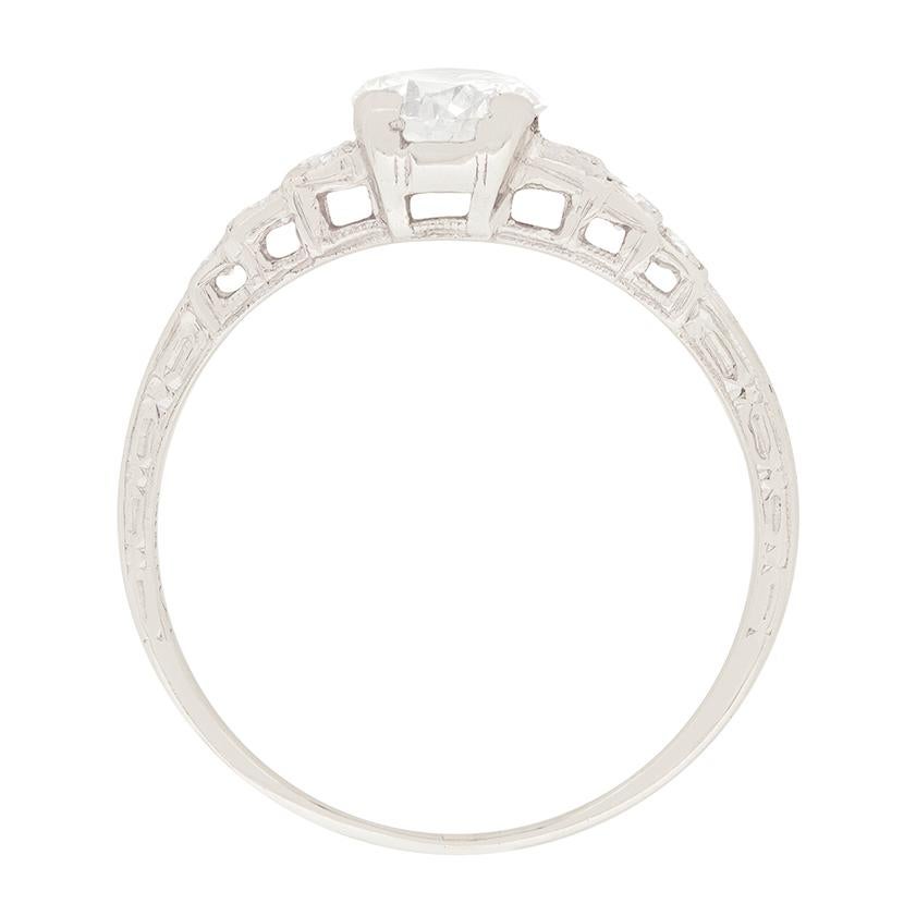 This beautiful art deco engagement ring features a 0.75 carat diamond, highlighted by diamond set shoulders. The diamond is and H colour and VS2 clarity, and captures the light beautifully. Three single cut diamonds are set on each shoulder,