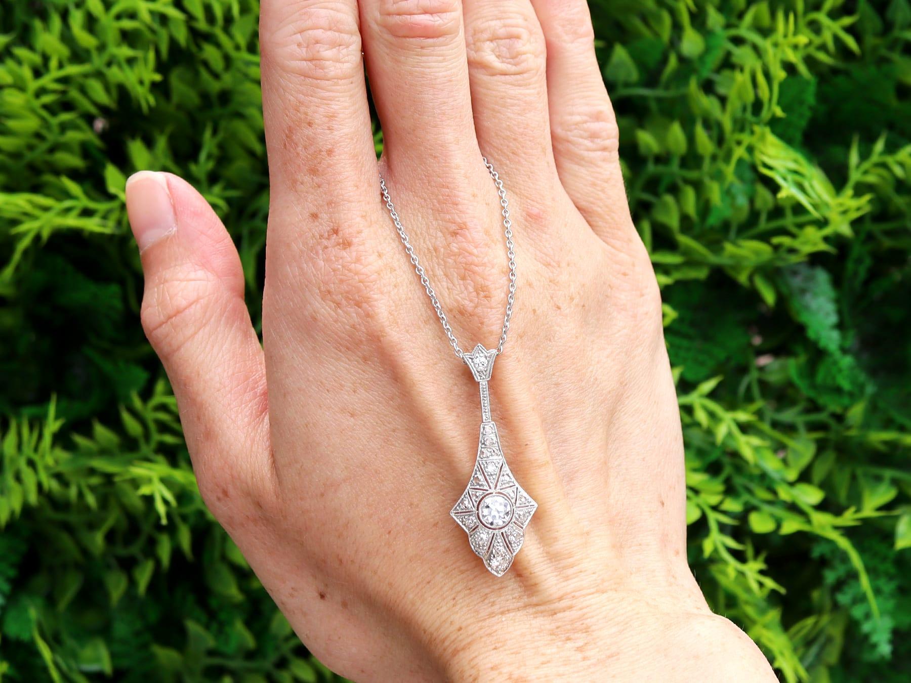 A stunning, fine and impressive antique Art Deco 0.76 carat diamond, 14k yellow gold and platinum set pendant; part of our diverse antique jewellery and estate jewelry collections. 

This stunning, fine and impressive antique Art Deco pendant has