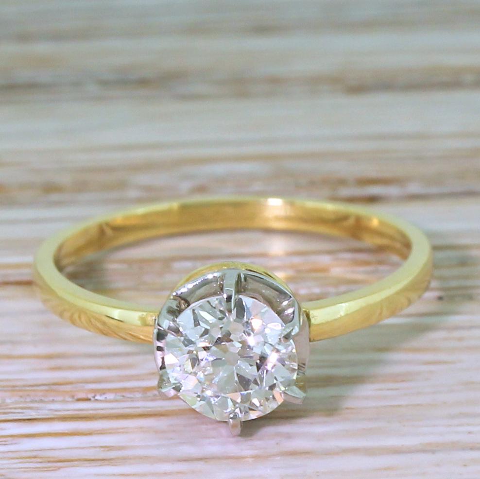 A honed back and stunning vintage diamond ring. The old mine cut diamond in a six claw platinum collet with an open gallery, allowing maximum light to pass through the diamond. Atop a slim and simple 18k yellow gold shank.

Accompanied by an