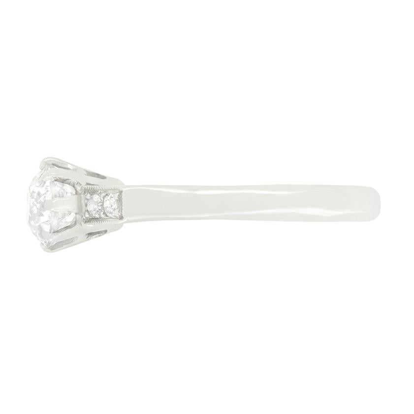 This classic solitaire ring dates back to the 1920s and the Art Deco period. A 0.80 carat, old cut diamond takes centre stage, claw set into a hand crafted platinum collet. The diamond has a colour of H and clarity of SI2. Across raised shoulders,