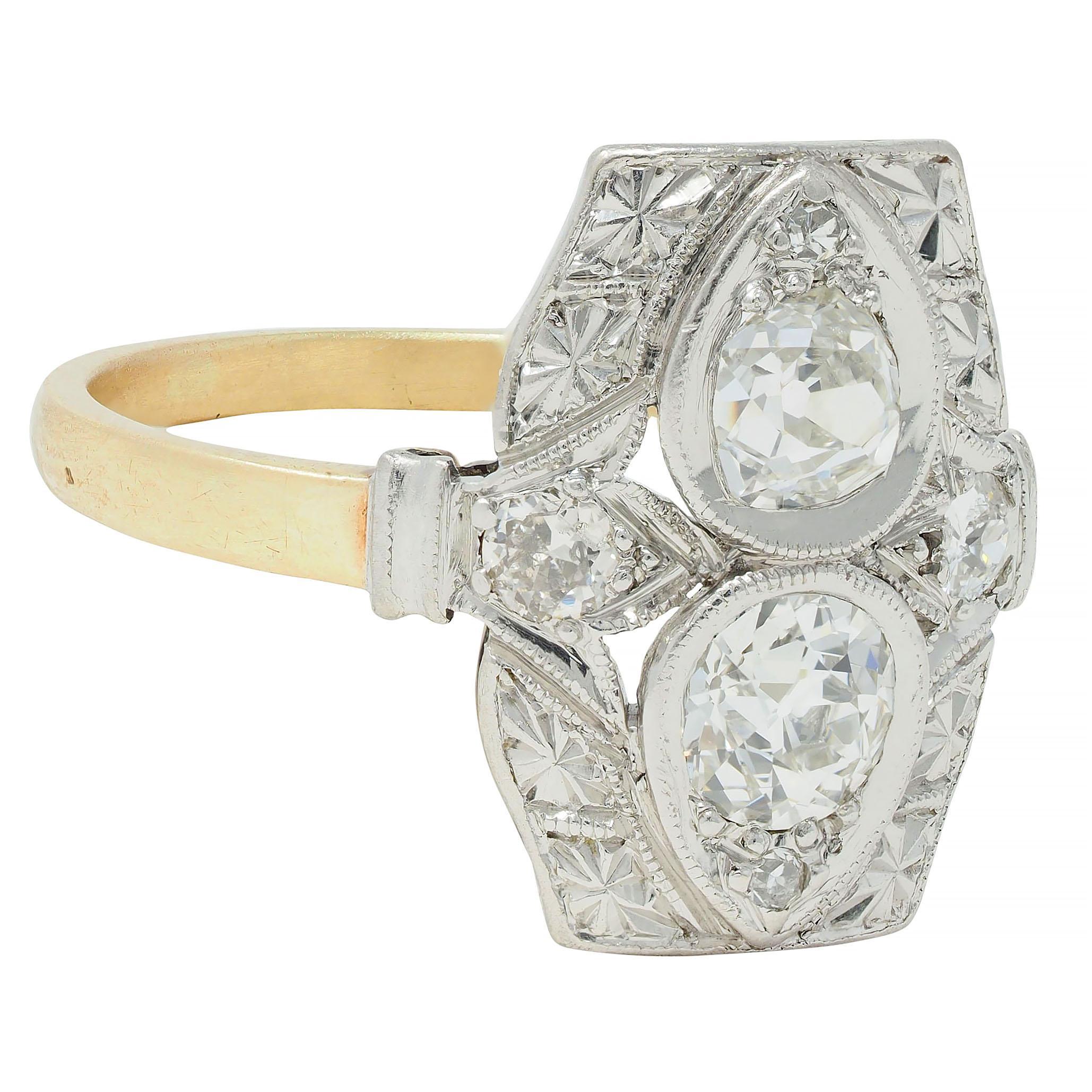 Featuring two old mine cut diamonds bead set north to south in pear-shaped forms 
Weighing approximately 0.66 carat total - I to K color with VS2 clarity
With a platinum cushion-shaped surround engraved with orange blossom motif 
Flanked by old