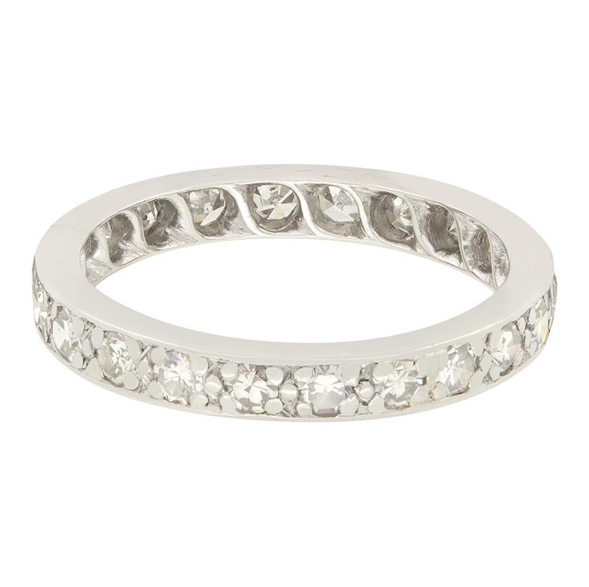 A total of twenty two glittering diamonds adorn this beautiful eternity ring dating back to the Art Deco period. The eight cut diamonds, totalling 0.88 carat are all grain set into the platinum band. The stones range in colour from G to H and match
