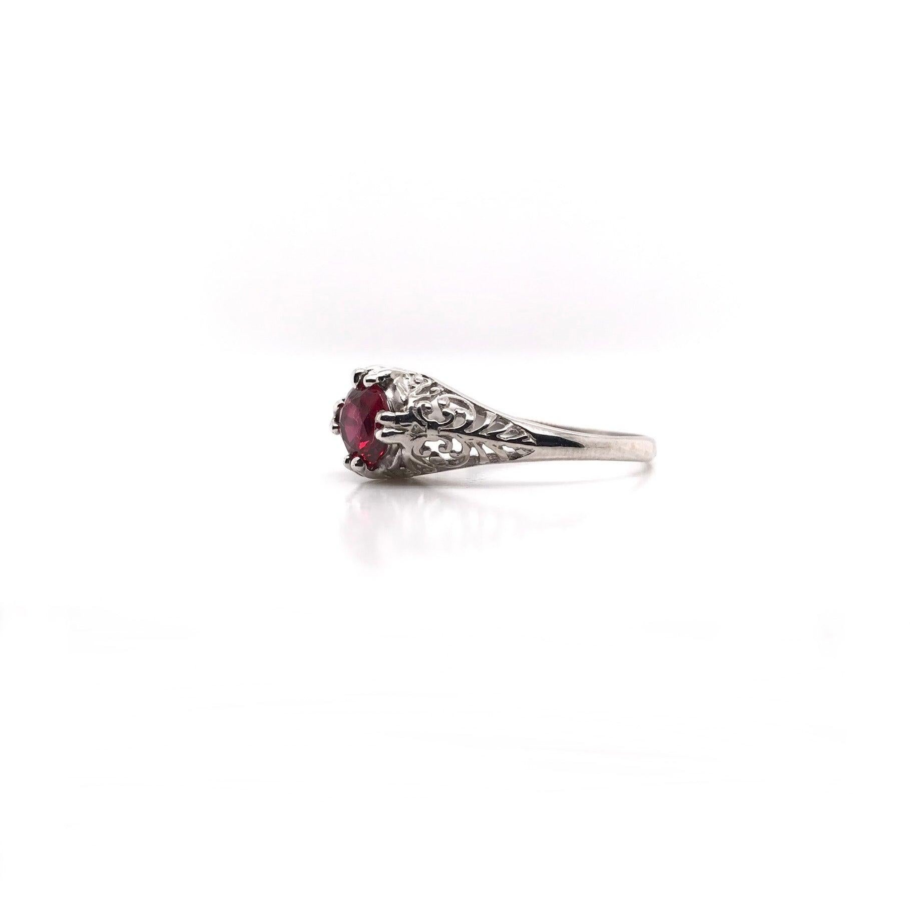 This antique piece was handcrafted sometime during the Art Deco design period ( 1920-1940 ). The center stone is a gorgeous, richly hued, ruby. The color is rich, vibrant, and absolutely captivating. The center ruby measures approximately 0.92