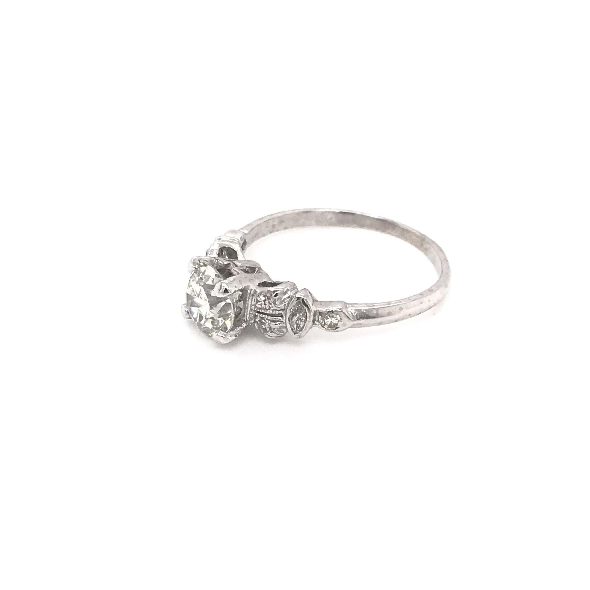 This antique piece was handcrafted sometime during the Art deco design period ( 1920-1940 ). The platinum setting is a sweet and simple solitaire style. The center diamond measures approximately 0.95 carats and grades approximately J in color, SI2