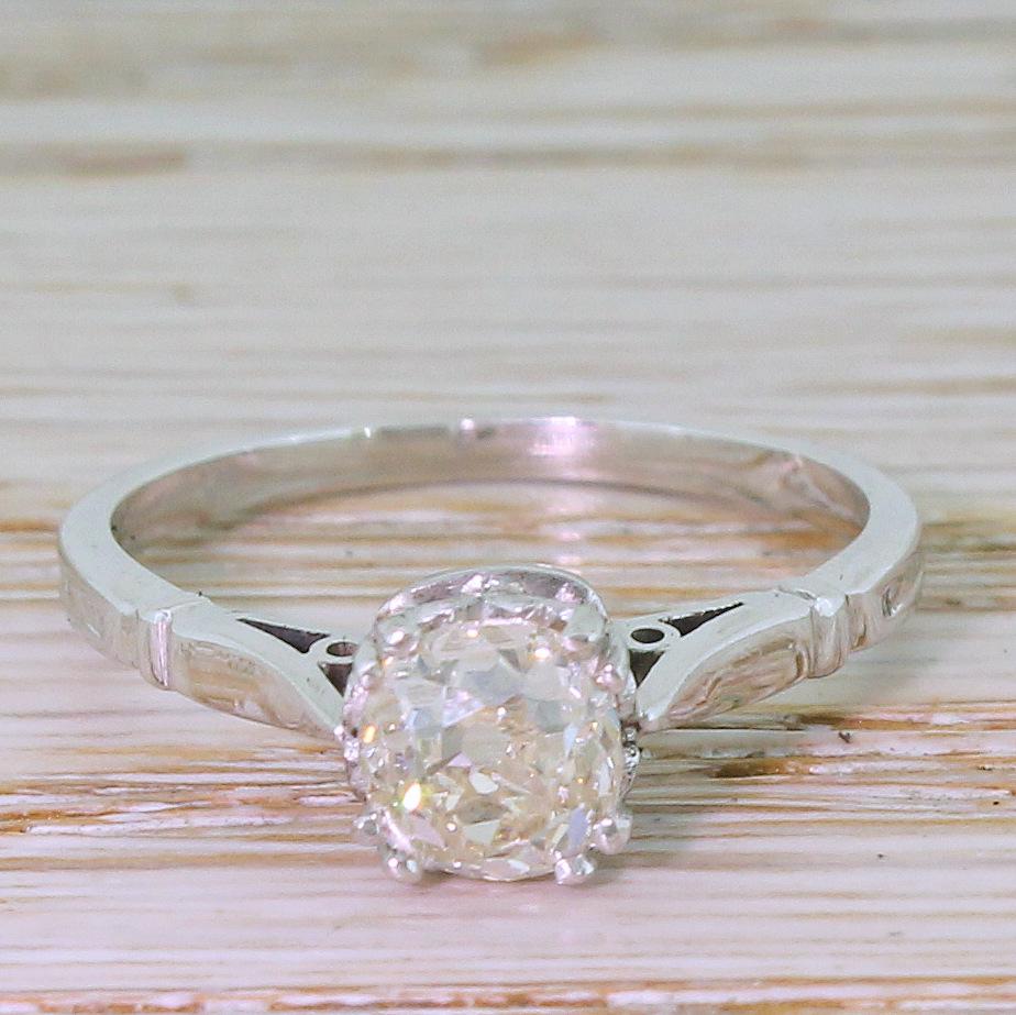 A seriously pretty old cut engagement ring. At the centre of this quite lovely solitaire is a cushion shaped old mine cut diamond – certified by HRD Antwerp as J colour, VS1 clarity – which is internally clean and very, very lively. The stone is