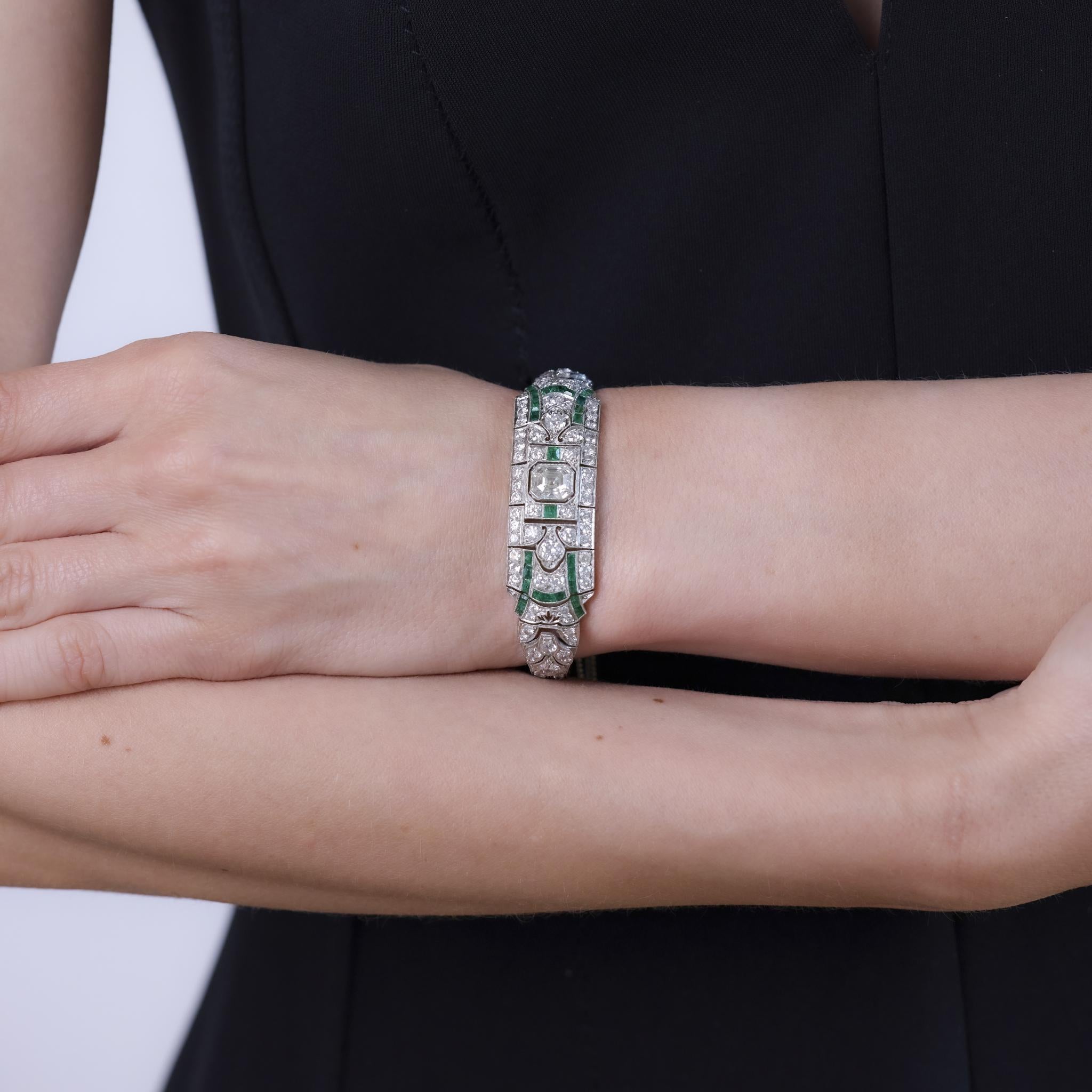 This exceptional Art Deco bracelet from the 1930s is crafted in platinum and features an Asscher cut diamond weighing approximately 1.90 carats, graded K color and VS clarity. It is accented by 156 old European cut diamonds totaling approximately