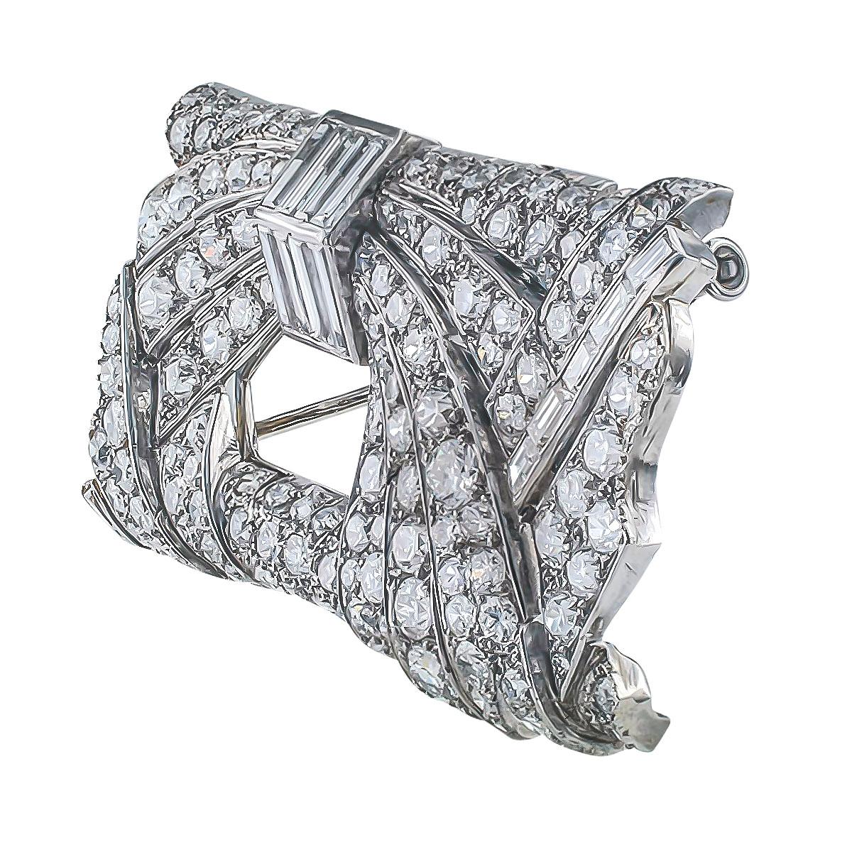 Art Deco Diamond and platinum brooch circa 1930.

DETAILS:
Art Deco 10.00 carats diamond and platinum brooch.
DIAMONDS: one hundred forty-six baguette and circular-cut diamonds totaling approximately 10.00 carats, approximately G – H – I color and