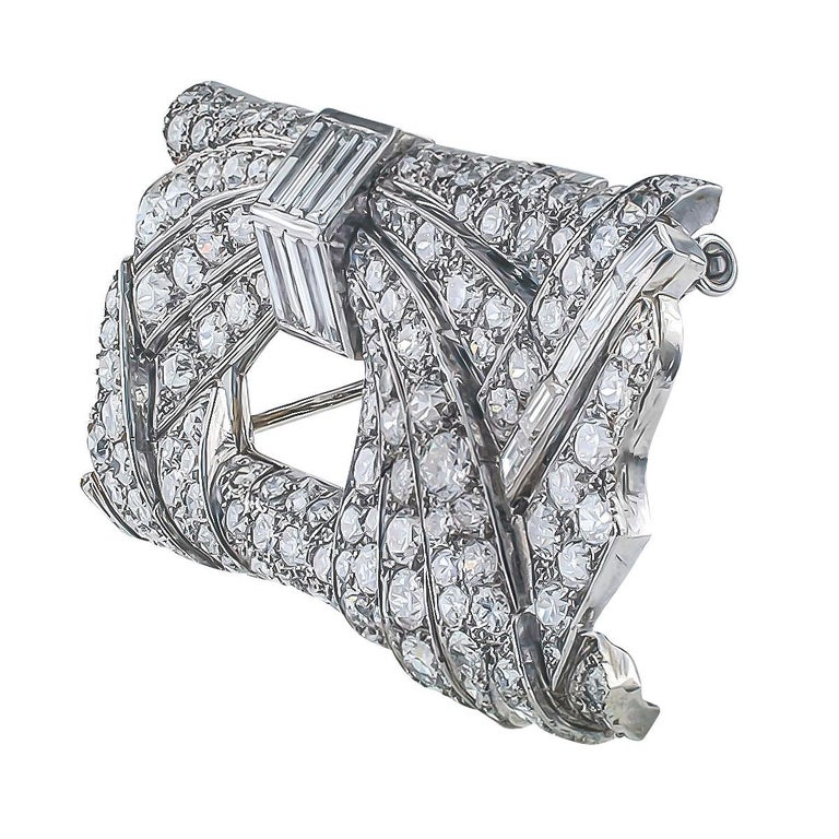 Art Deco Diamond and platinum brooch circa 1930.

DETAILS:
Art Deco 10.00 carats diamond and platinum brooch.
DIAMONDS: one hundred forty-six baguette and circular-cut diamonds totaling approximately 10.00 carats, approximately G – H – I color and