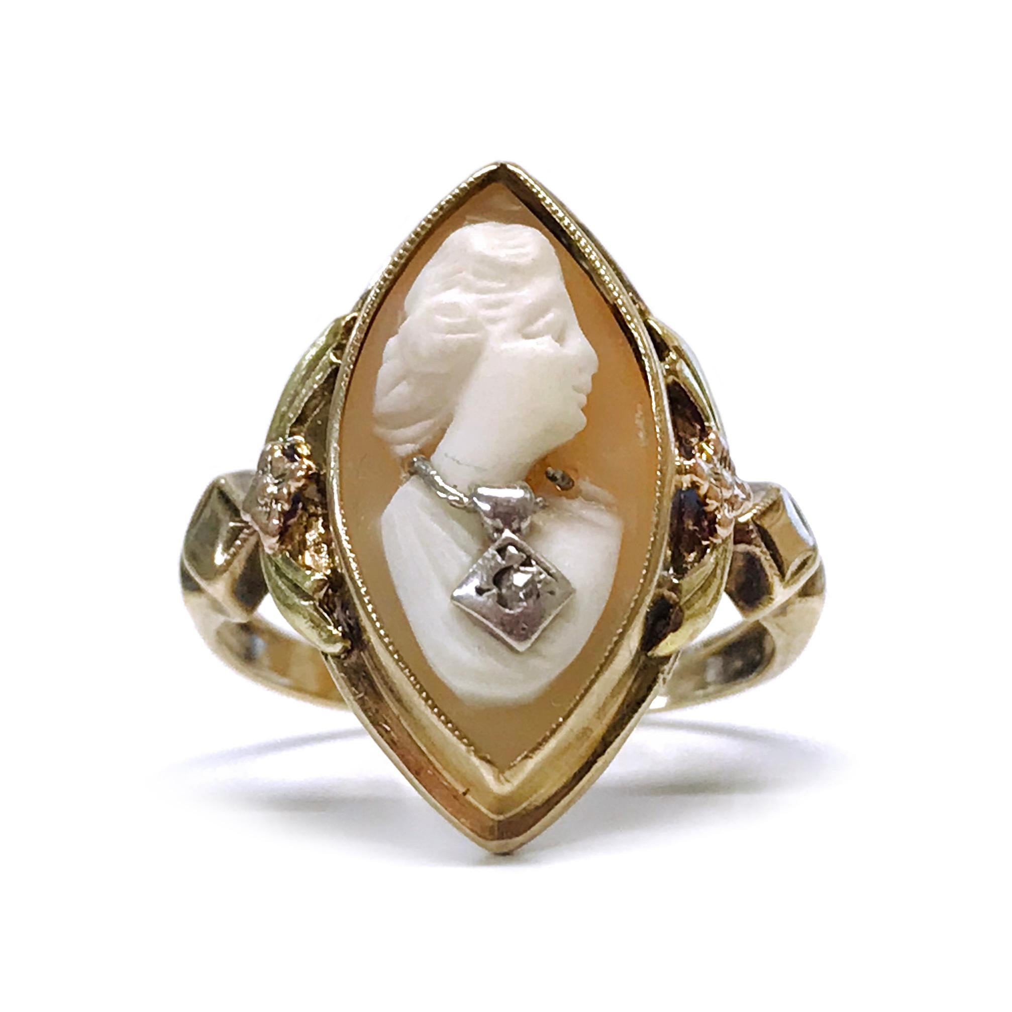 Art Deco 10 Karat Tri-Tone Yellow, Rose, and White Gold Cameo Diamond Ring. The navette-shaped ring has a bezel-set cameo. The carved shell cameo is a profile of a woman wearing a white gold necklace, the necklace has a single round meller diamond