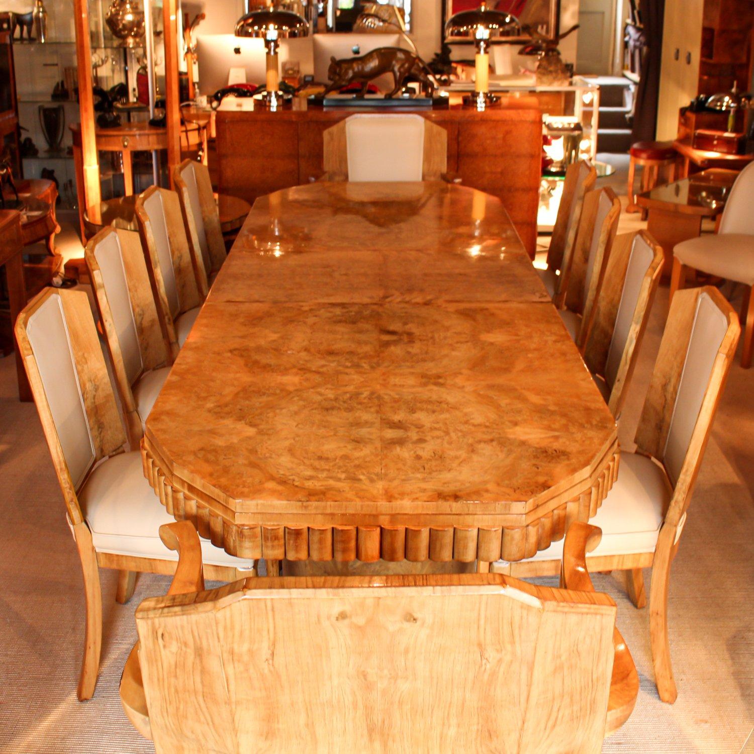 An Art Deco, walnut veneered dining table with ten chairs (eight chairs and two arm chairs) by Hille. Refurbished, re-polished and re-upholstered in cream leather.

Dimensions: H 78cm L 265cm W95cm
Armchair Seat W 66cm, seat D 50cm, seat H 46cm,