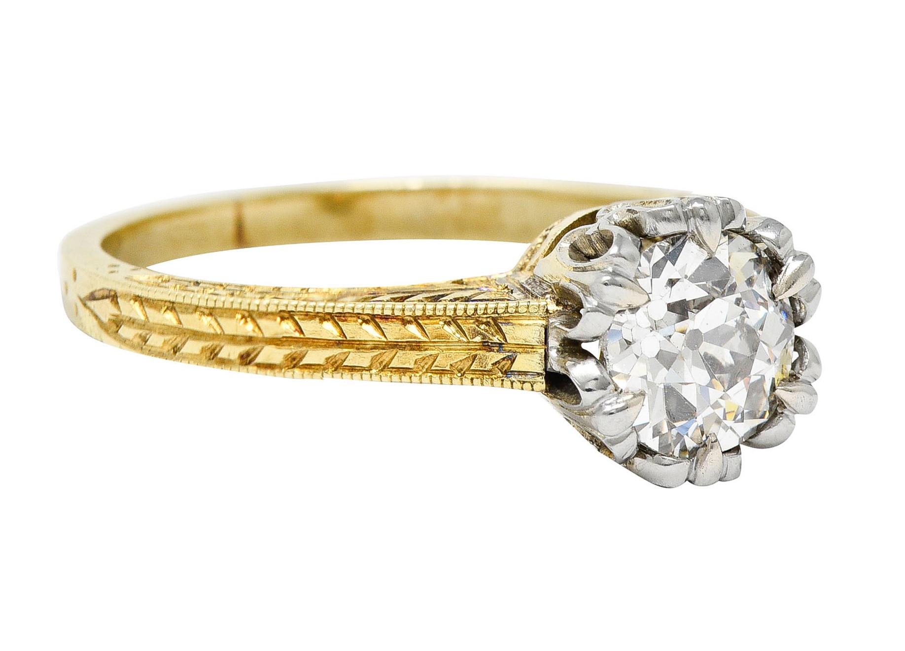 Featuring an old European cut diamond weighing approximately 1.00 carat - J color with VS2 clarity

Set in a platinum head with a stylized and looping fleur-de-lis motif

With a substantial yellow gold shank hand engraved with a wheat motif

Stamped