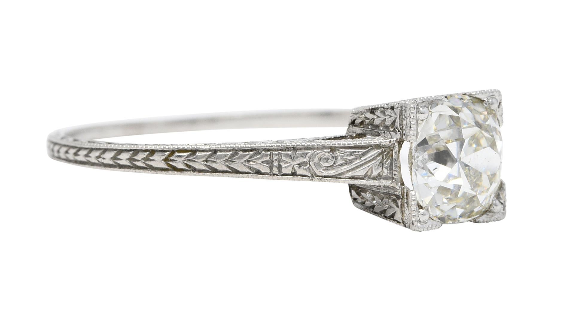 Featuring an old European cut diamond weighing approximately 1.00 carat - K color with SI1 clarity

Set in a square form head and flanked by subtle cathedral shoulders

Engraved throughout with a stylized wheat motif

Tested as platinum

Circa:
