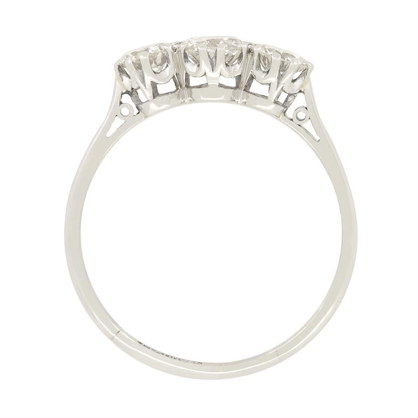 This classic Art Deco three stone ring beautifully showcases a trio of transitional cut diamonds. The central diamonds is the largest, at 0.40 carat with the flanking pair weighing 0.30 carat a piece. All three diamonds are of high quality with a