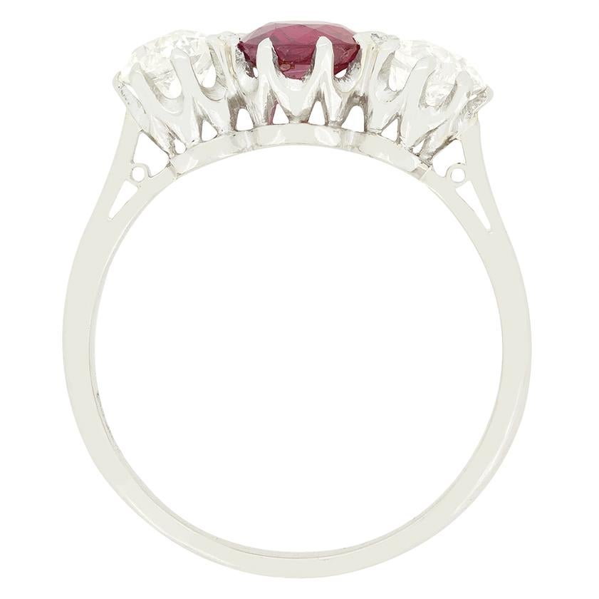 Dating back to the 1920s is this trilogy ring featuring a natural ruby to the centre set between a matching pair of old cut diamonds. The unheated central ruby weighs 1.00 carat, whilst the accompanying diamonds weigh 0.50 carat a piece. The