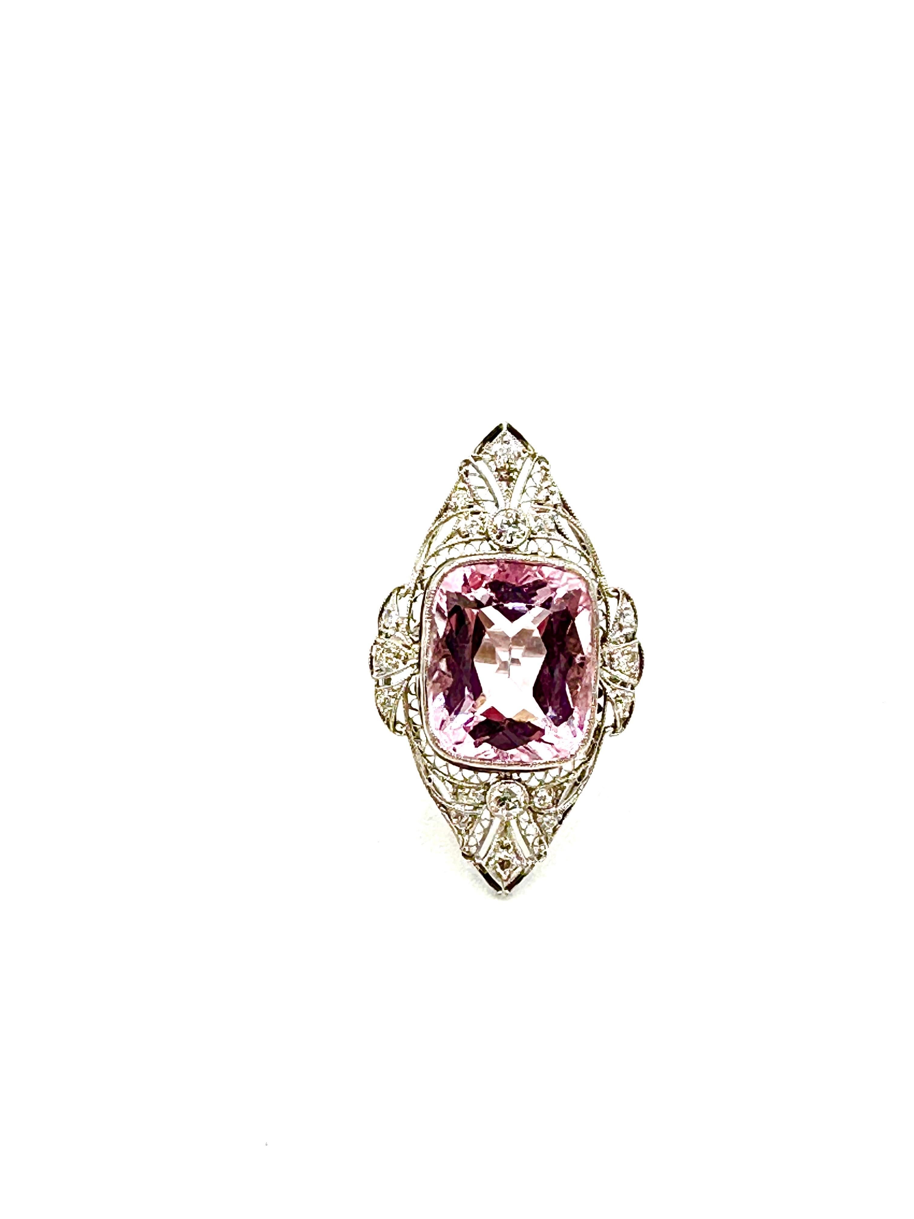 An amazing 10.12 carat Kunzite and Diamond Art Deco style cocktail ring.  The Kunzite is cushion shape, bezel set in a milgrain edge frame, with Diamonds set in an open filigree top.  The 18 Diamonds have a total weight of 0.50 carats.  The ring is