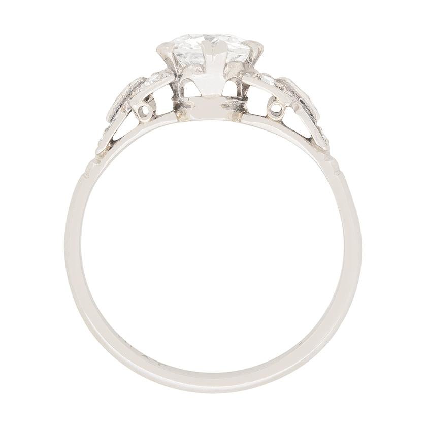 Dating back to the 1920s, this hand crafted solitaire features a beautiful 1.01 carat old cut diamond. The stone is claw set into platinum and is graded H in colour and VS in clarity. Accompanying the centre diamond is a further ten eight cut