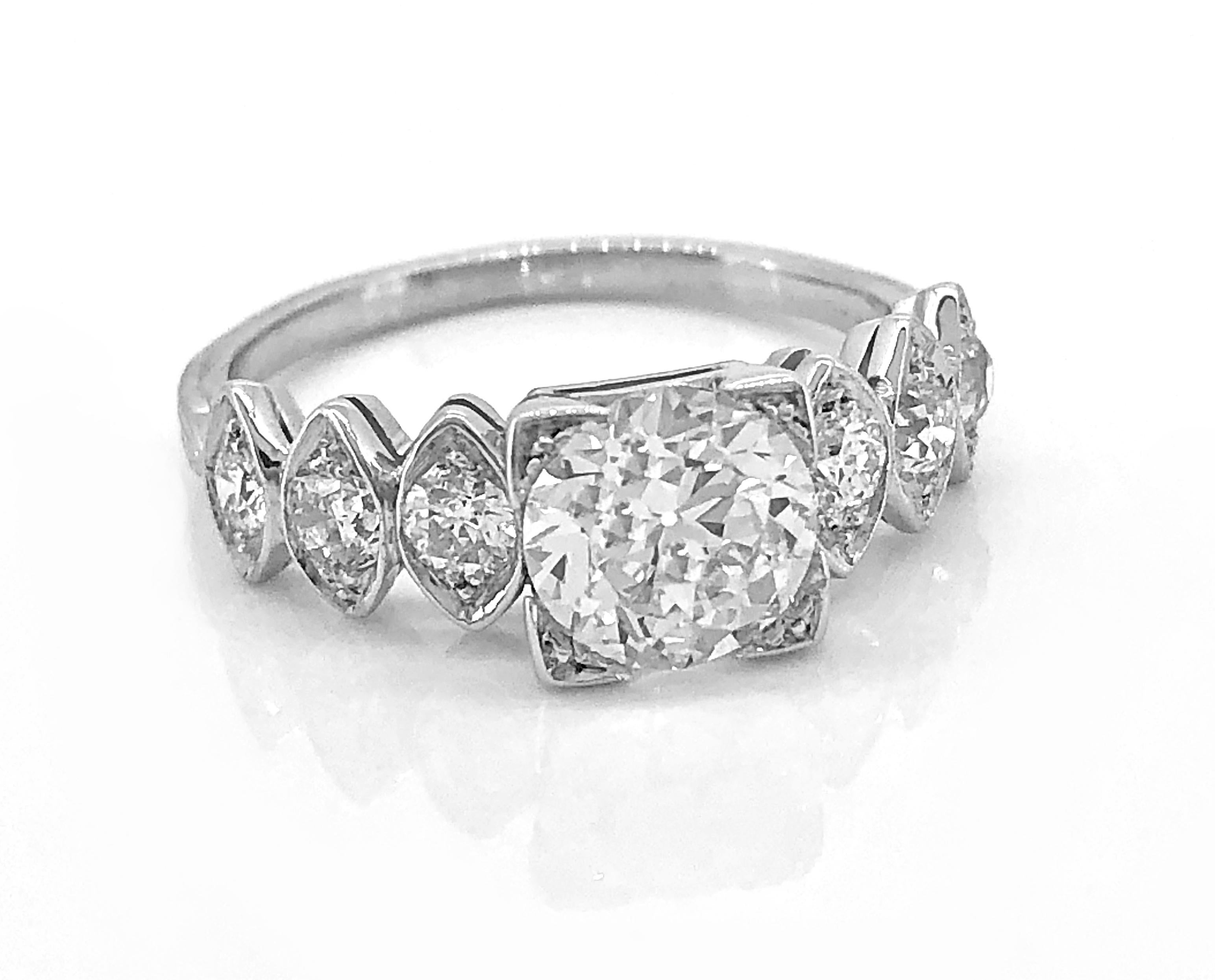 This is a beautiful antique engagement ring featuring a 1.02ct. apx. European cut center diamond set with trefoil prongs. The clarity is VS1 and I-J color. The .33ct. apx. T.W. of accenting diamonds are set in marquise shaped designs on each side of