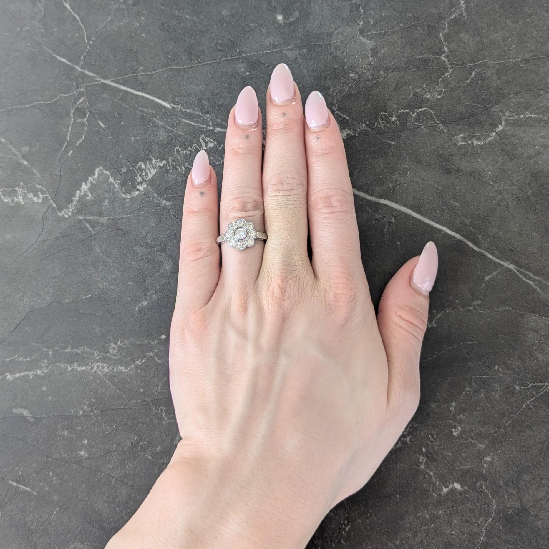 Centering an old European cut diamond weighing approximately 0.22 carat - H color with VS2 clarity
Bezel set with a pierced cluster surround of additional old European cut diamonds
Weighing approximately 0.80 carat total - H to I color with VS2