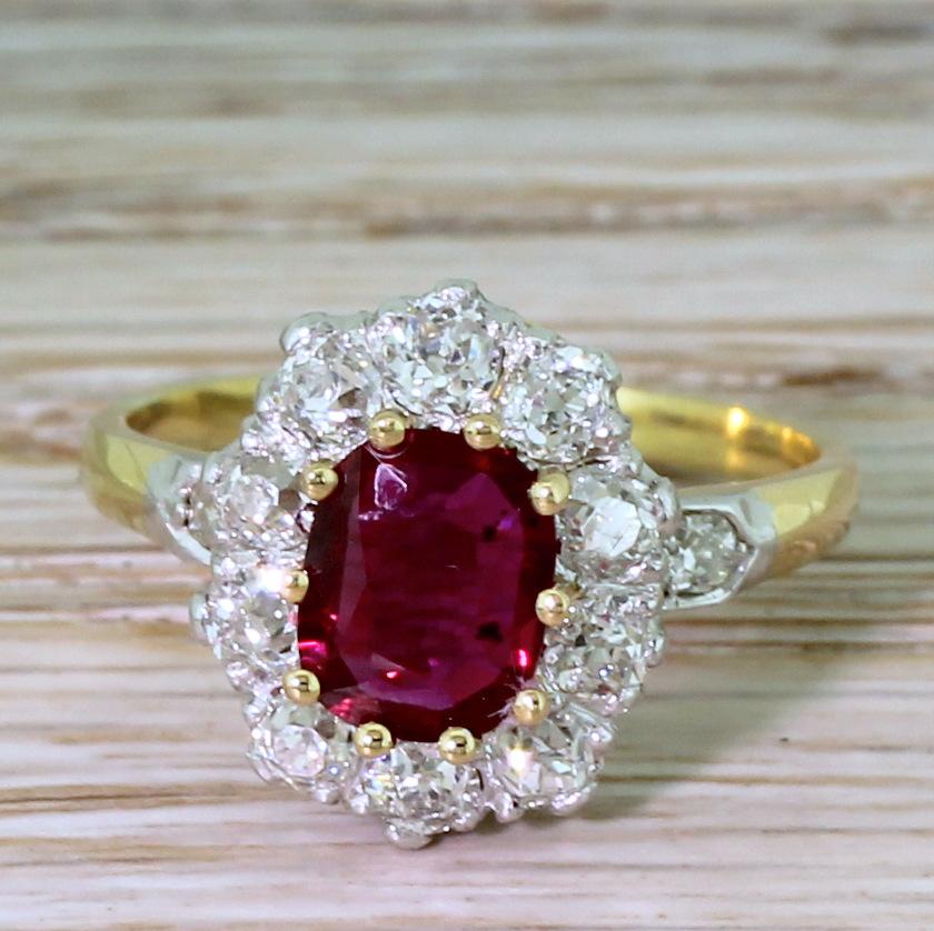Just about the ideal ruby and diamond ring. The natural, unheated ruby displays a rich, deep pigeon blood red – the colour of which is emphasised by ten white and clean old mine cut diamonds in the surround. The stones are secured in a platinum