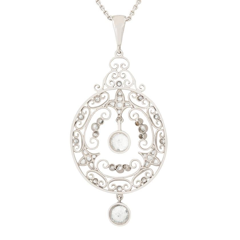This intricate necklace was crafted by hand in the 1920s. A combination of floral patterns and scrolls are adorned with sparkling diamonds. The main old cut diamond is 0.55 carat, and the diamond at the bottom is 0.50 carat. Additional smaller rose