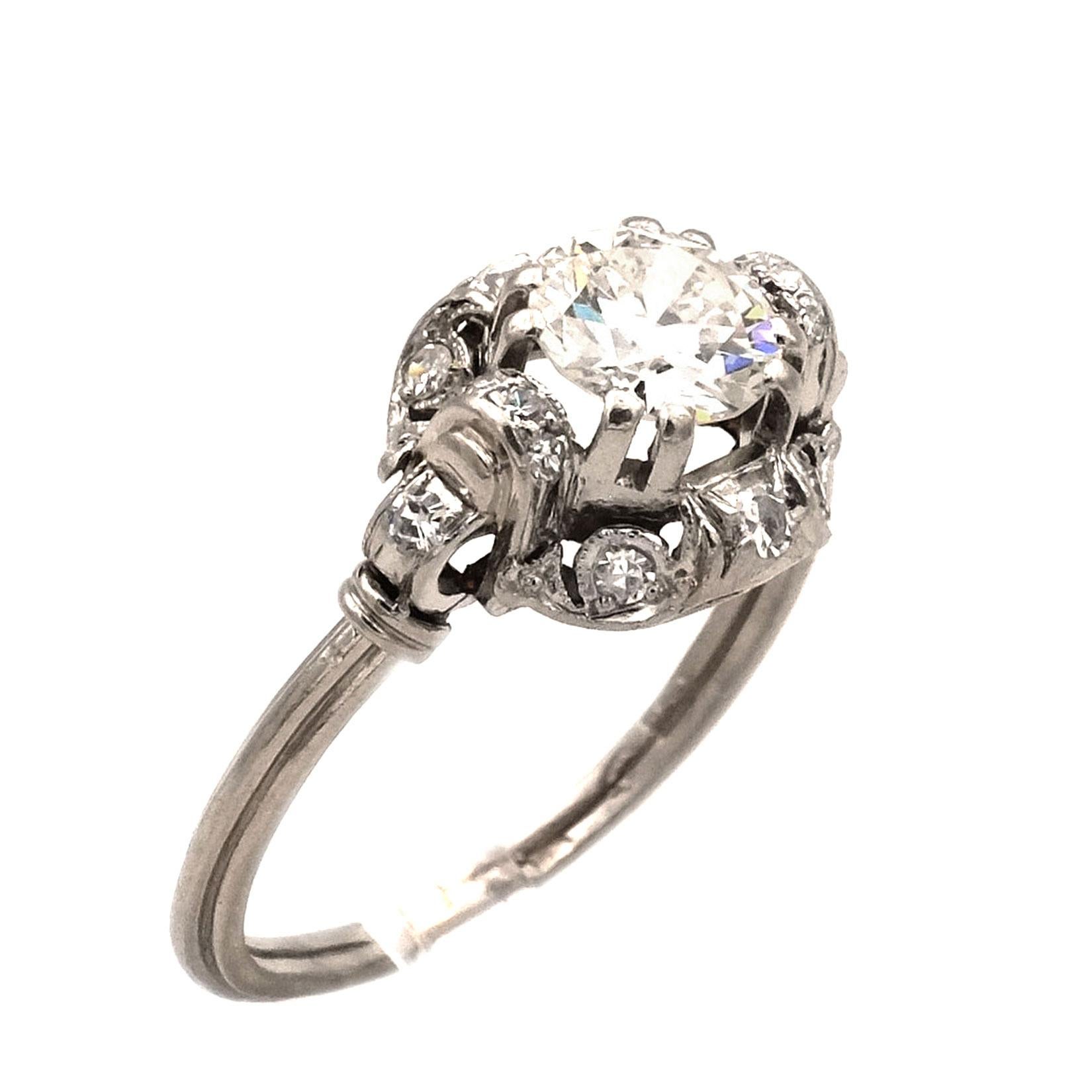 Art Deco 1.08 Carat Diamond Platinum Ring, circa 1920

This attractive diamond engagement ring features one round brilliant cut diamond of approx. 0.8 ct (G/VVSI) in an entourage of 14 further diamonds of approx. 0.28 ct. The 15 diamonds of the