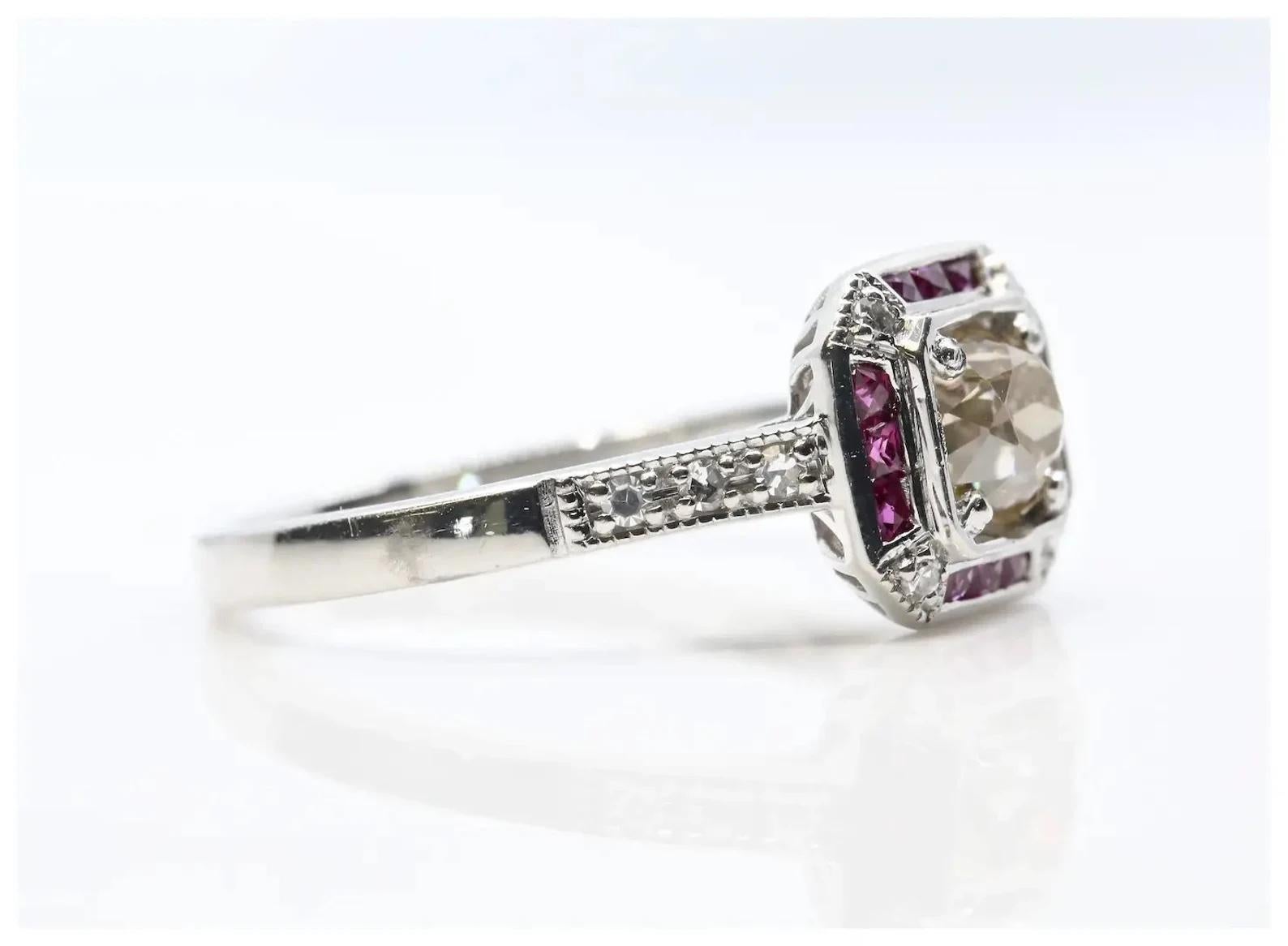 A beautiful Art Deco style champagne diamond, and ruby engagement ring in platinum.

Centered by a 0.50 carat old mine cut diamond of rich champagne color and VS2 clarity.

The diamond framed by a dozen French cut rubies of 0.48ctw, and ten pave set