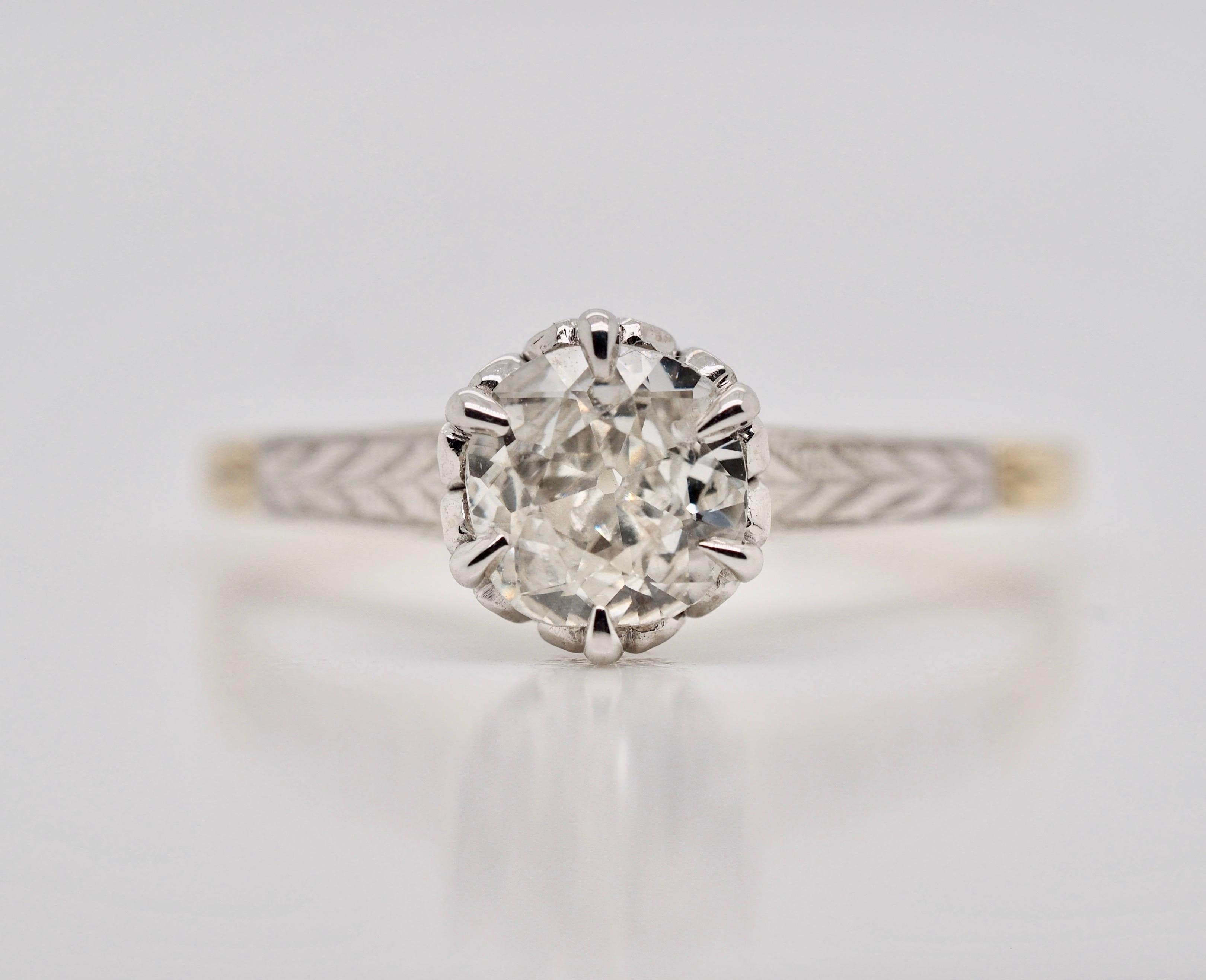 This amazing 10 karat yellow and white gold Art Deco solitaire engagement ring with six claw-prongs holds an Old Mine Cut Diamond measuring  5.90 - 5.63 x 2.65 mm and weighing approximately .53 carats I clarity  J - K in color. The prongs and 1/3