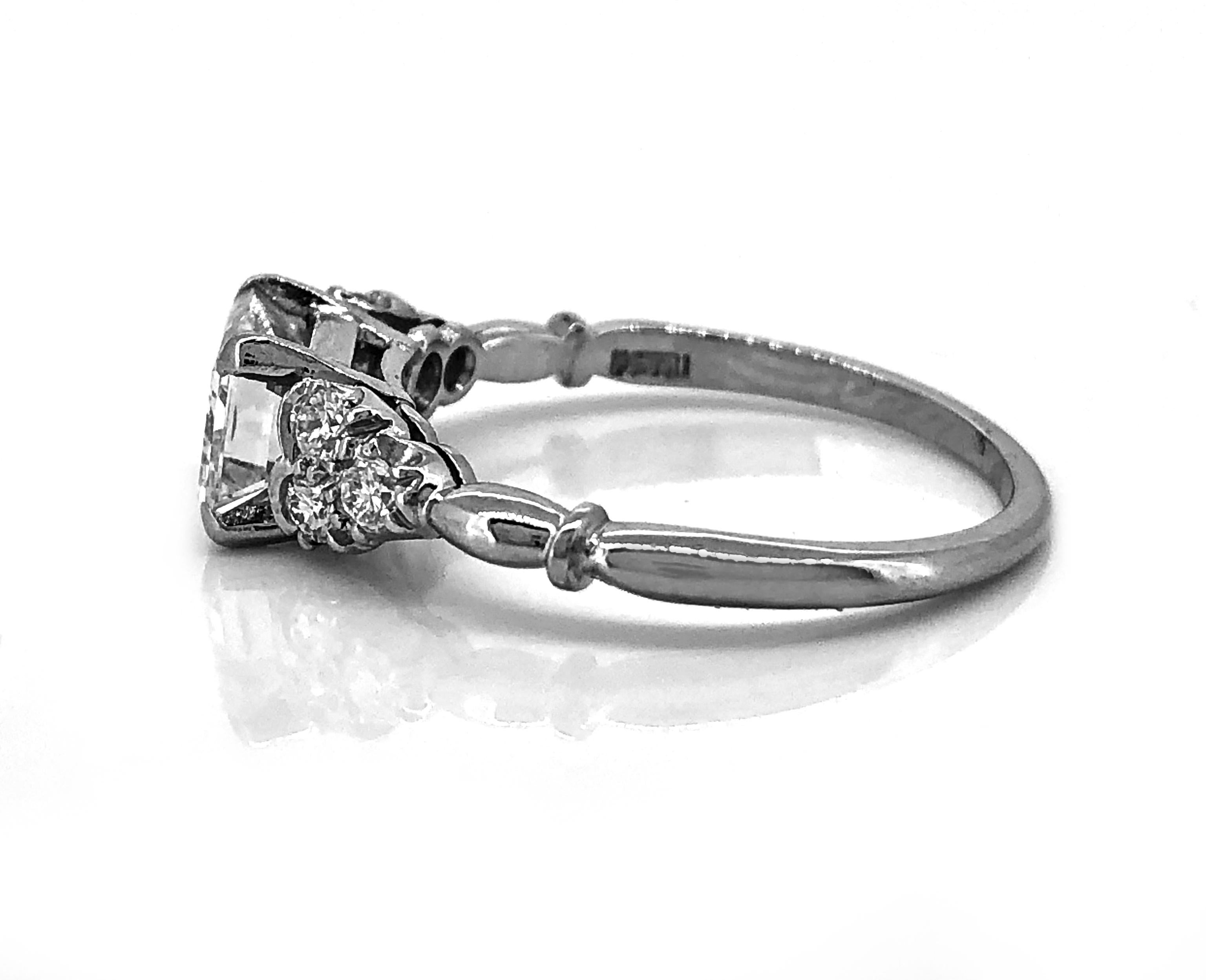 Crafted in platinum, this Art Deco diamond Antique engagement ring features a beautiful Emerald cut diamond in the center weighing 1.10ct. Apx. The Emerald cut has VS1 clarity and H color. Accenting European cut diamonds weigh .20ct. apx. T.W. with